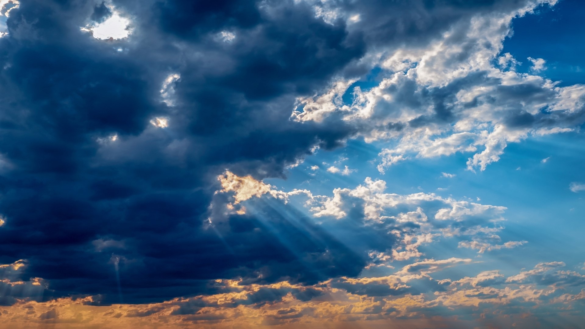 Sunbeams through dark clouds HD Wallpaper