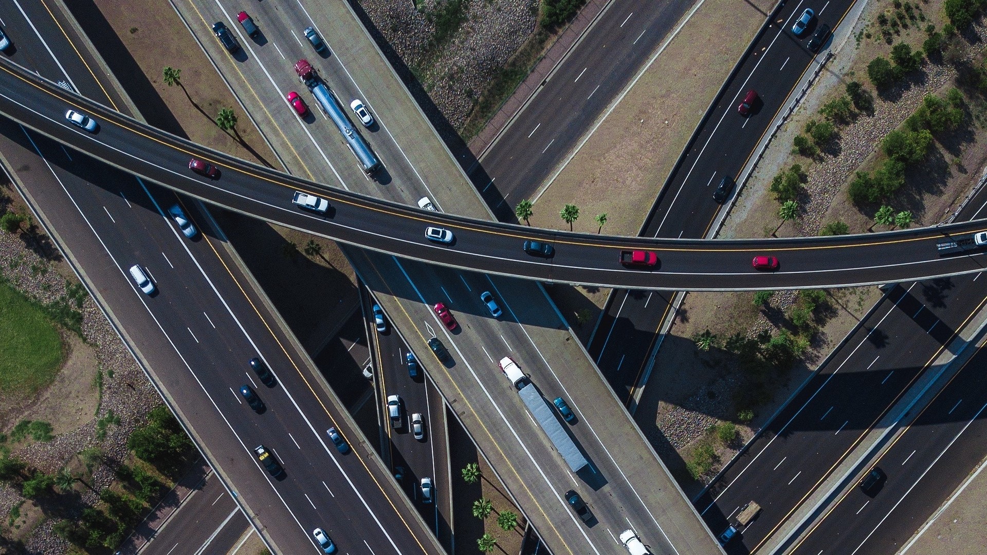 Aerial View of Highway Interchange with Traffic HD Wallpaper