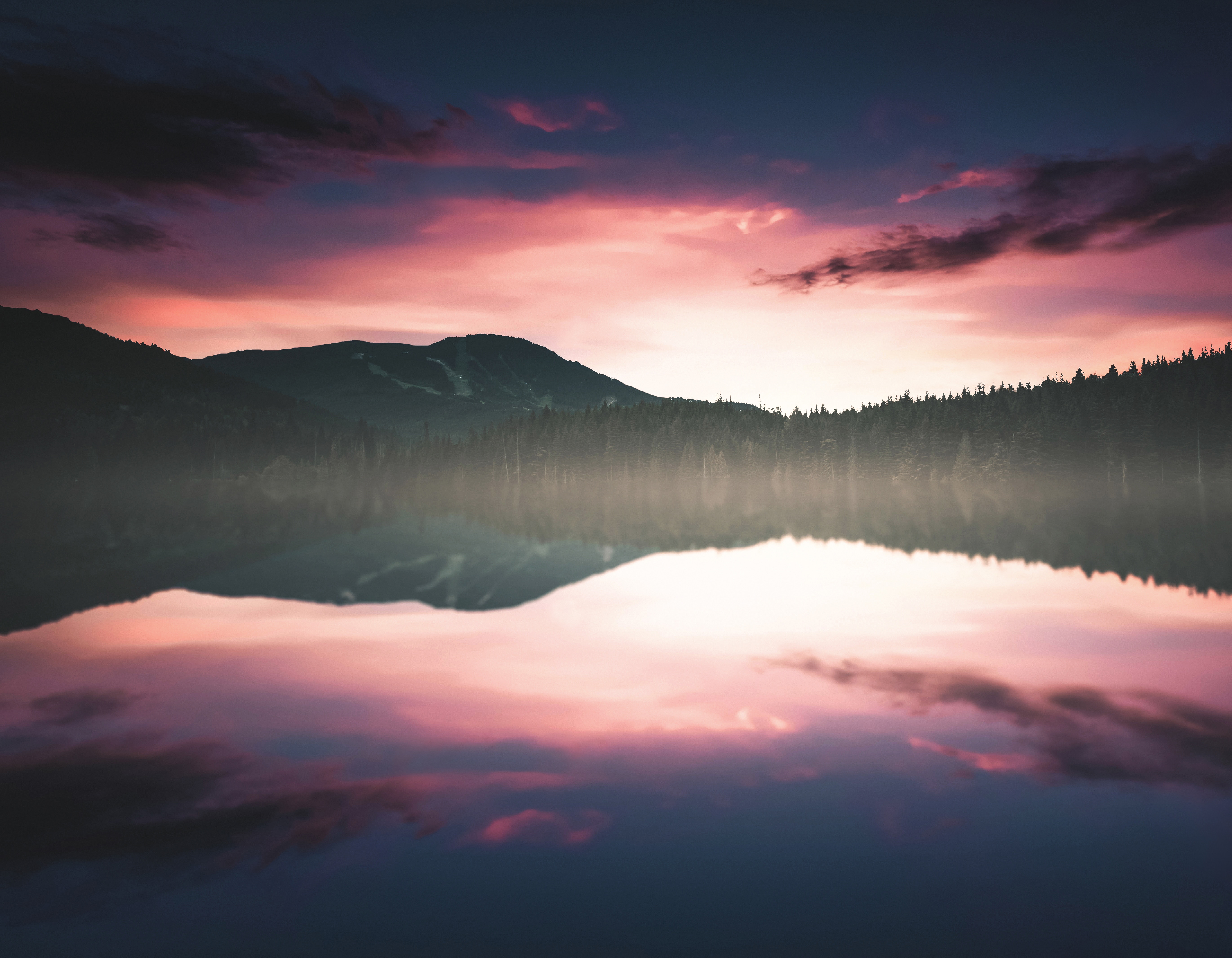 Lake reflections at sunset with mountains and forest HD Wallpaper