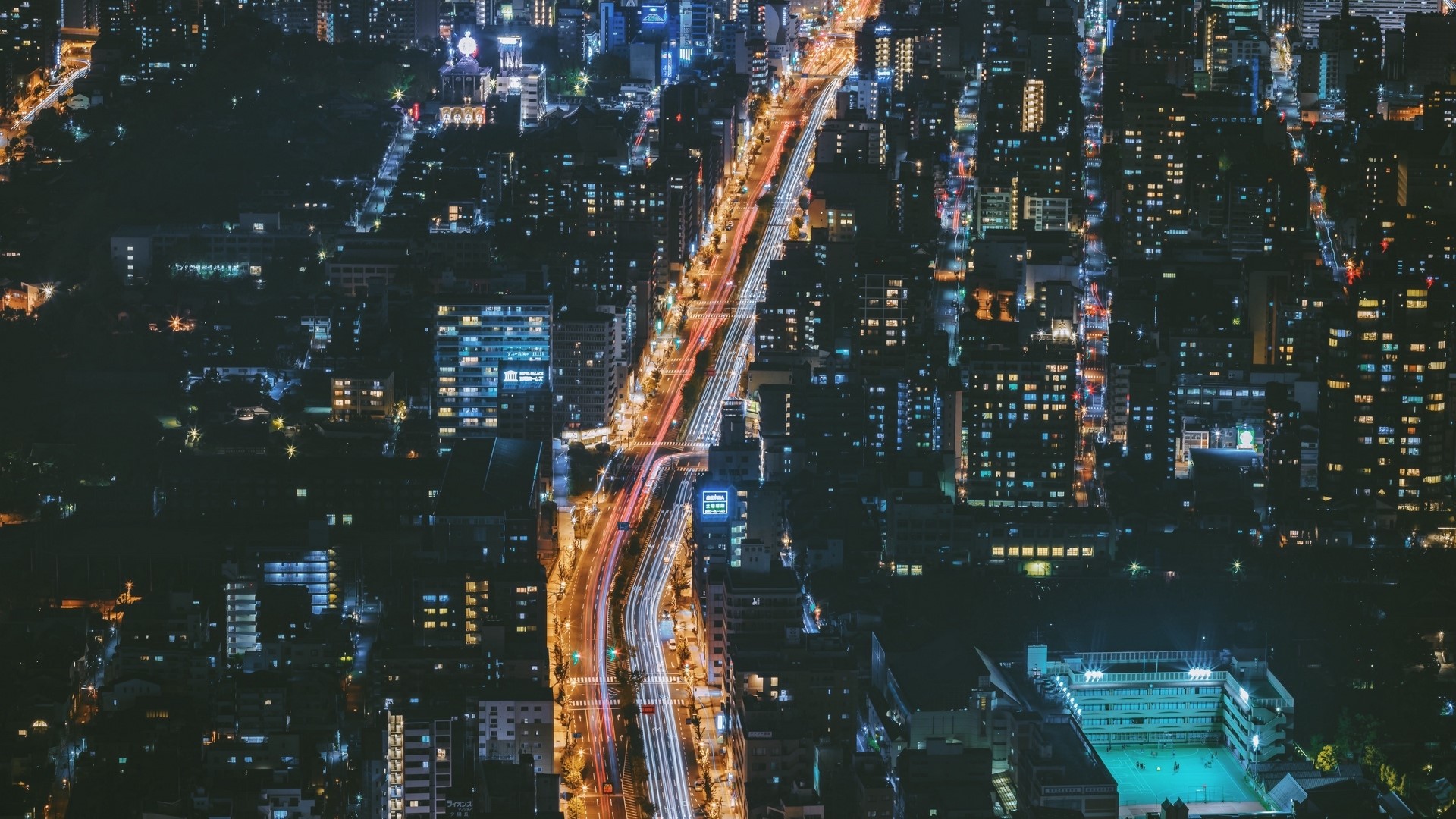 Nighttime cityscape with light trails in Osaka HD Wallpaper