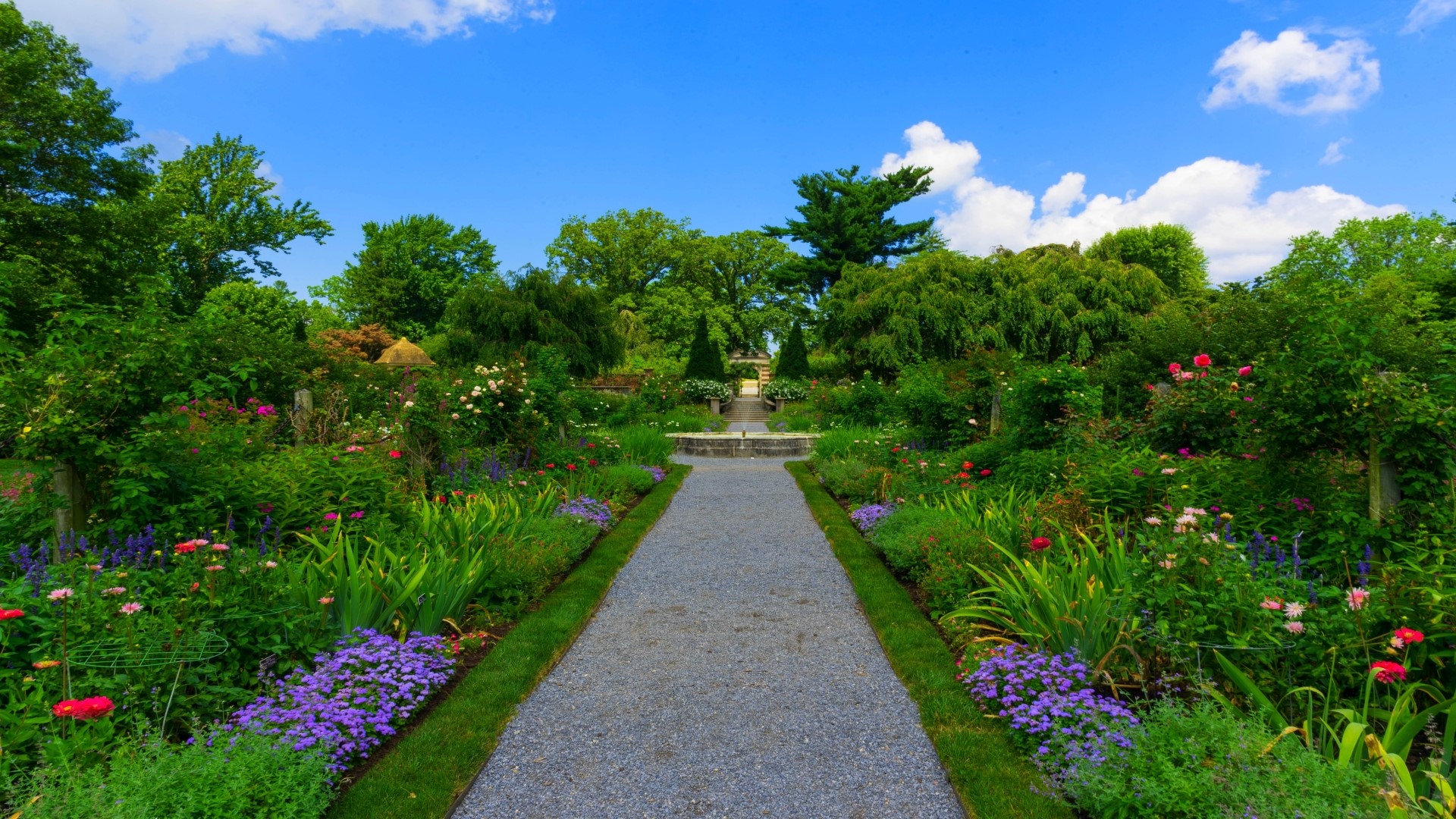 A beautiful garden path with flowers and trees HD Wallpaper