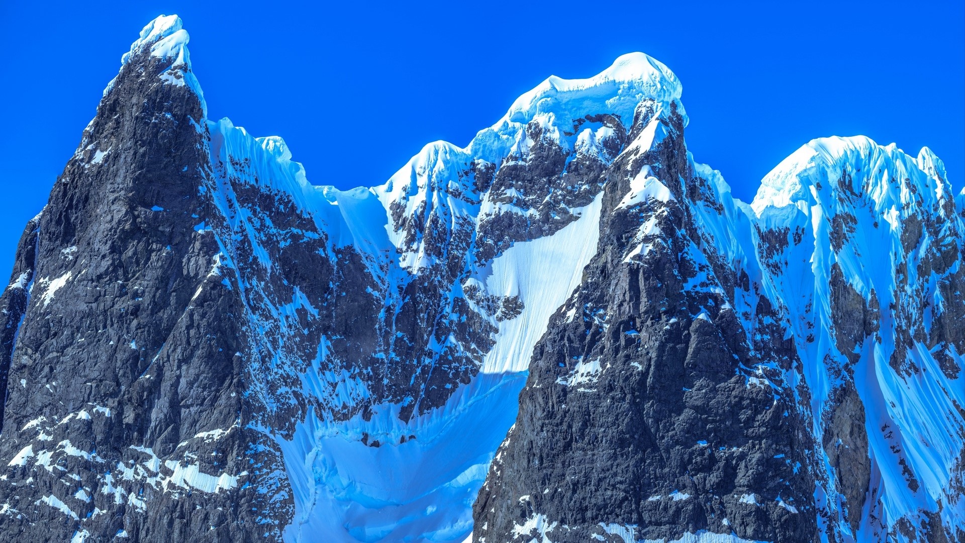 Snow-covered mountains under a clear blue sky HD Wallpaper