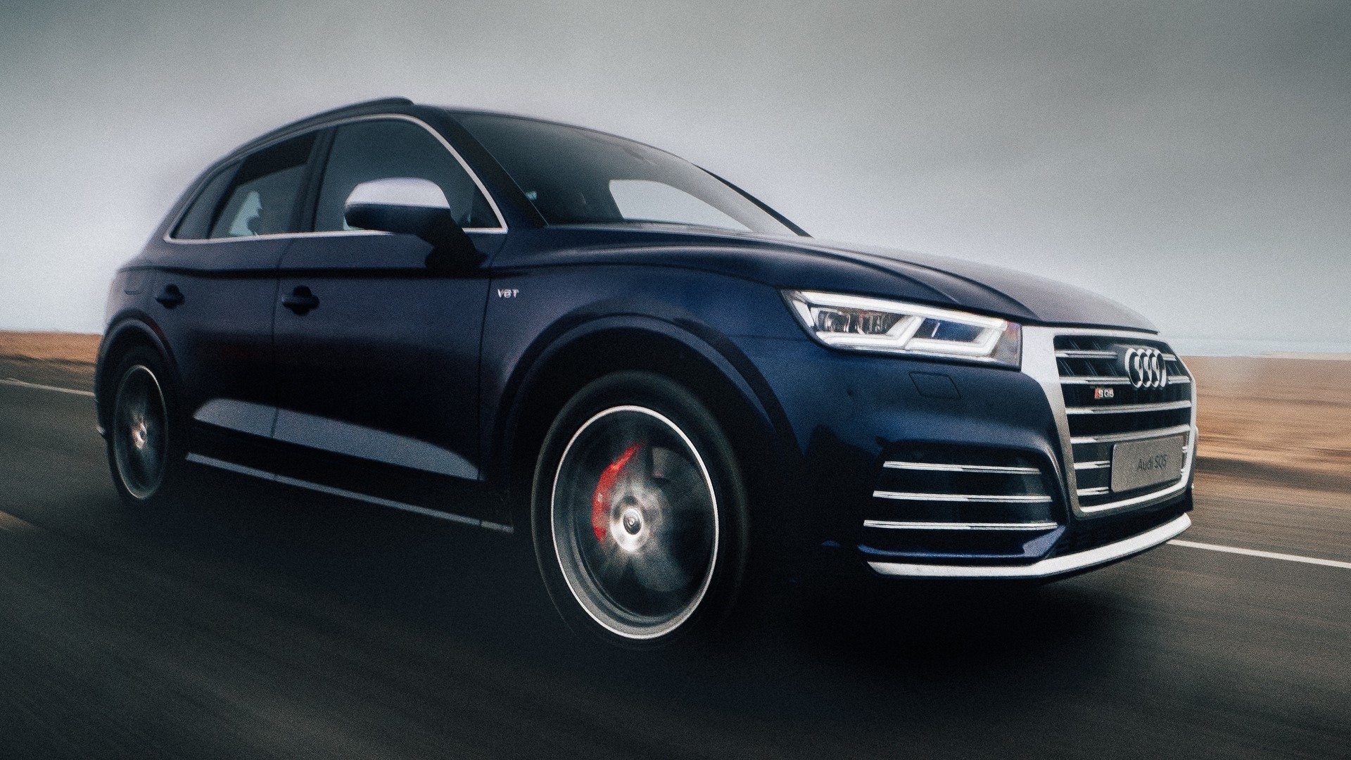 Dark blue Audi SQ5 driving on a road HD Wallpaper