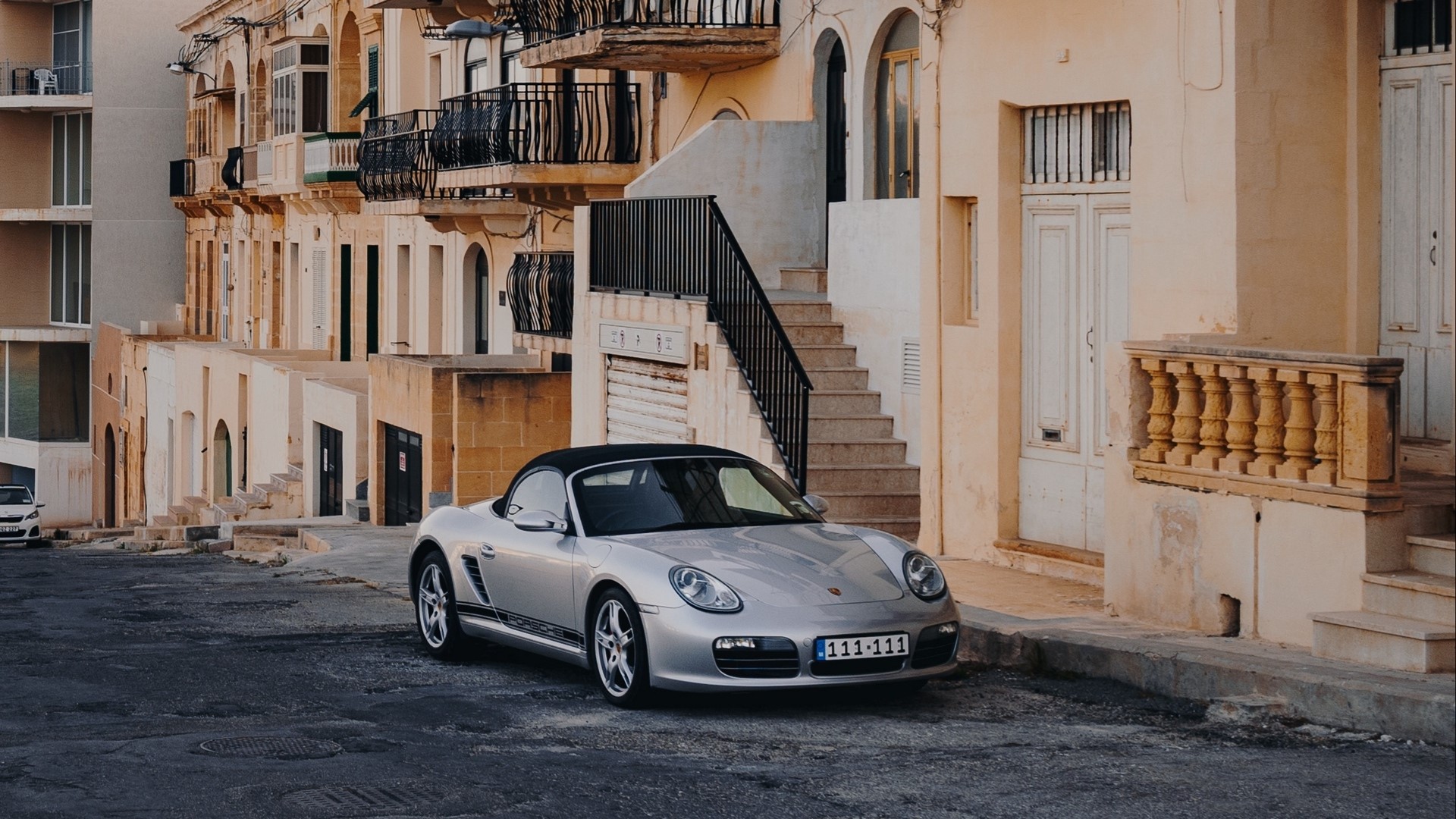 Silver Porsche Boxster parked on a street HD Wallpaper
