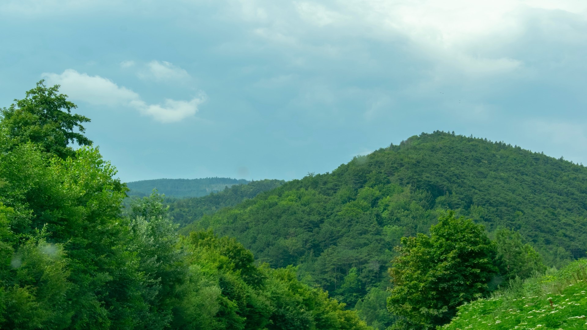 Green Hills and Cloudy Sky HD Wallpaper