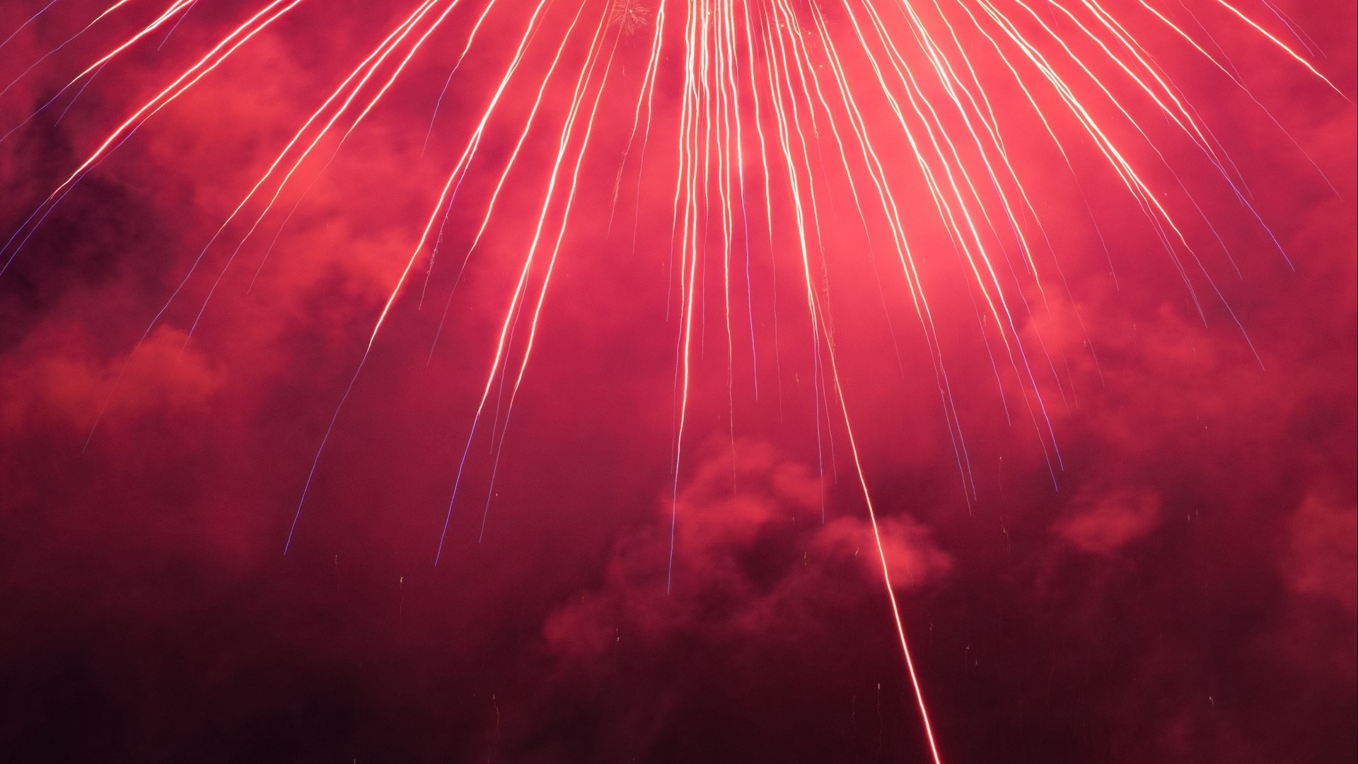 Red fireworks exploding in the night sky HD Wallpaper