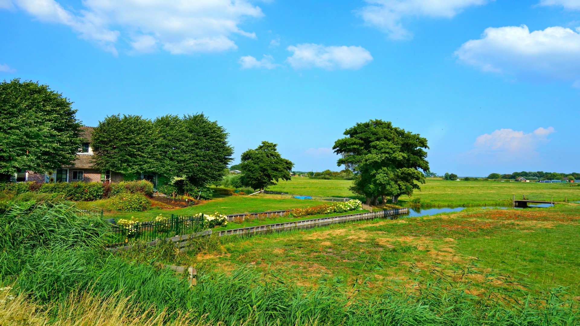 Green Landscape with House and Blue Sky HD Wallpaper