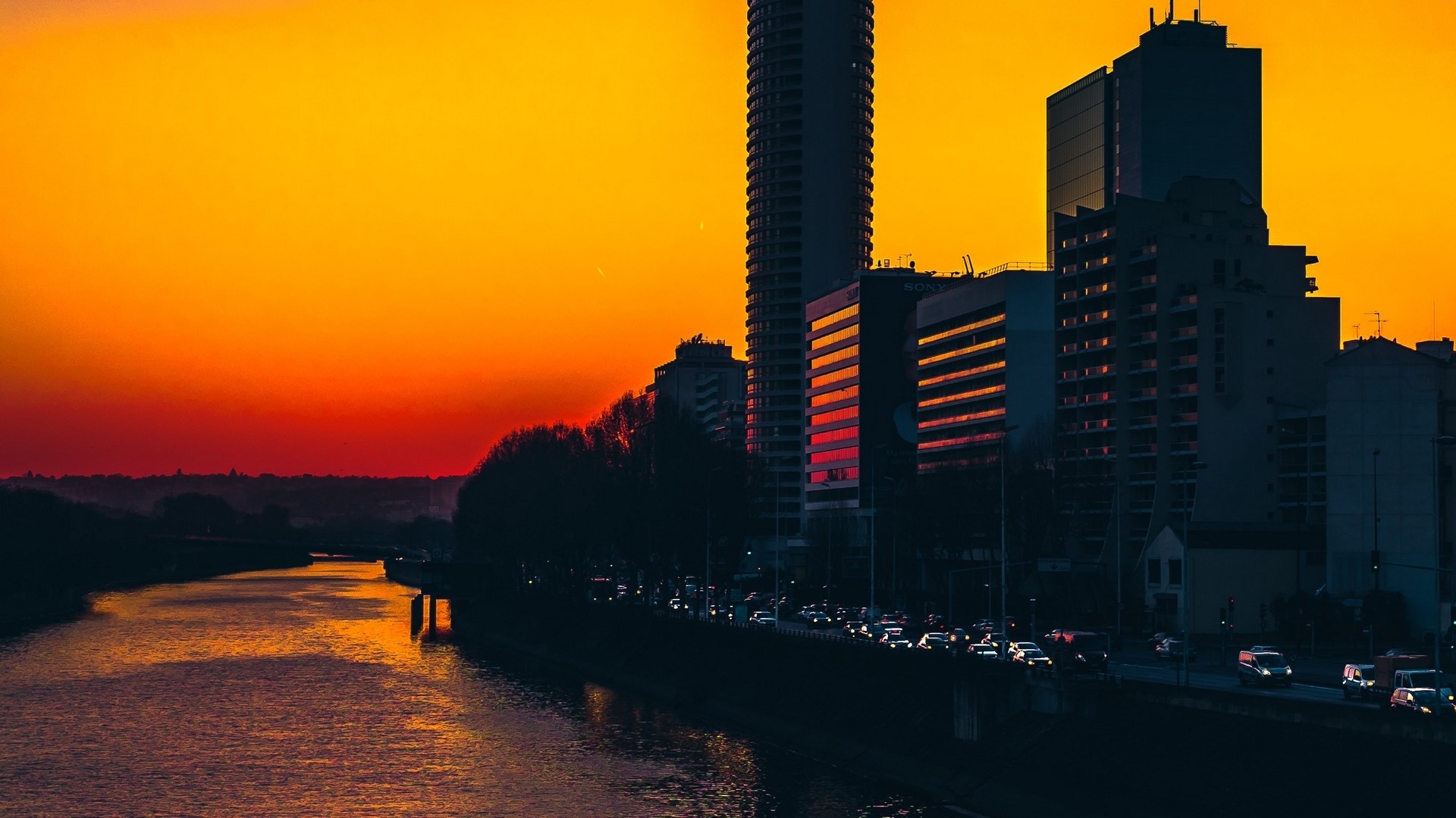 City skyline at sunset with river HD Wallpaper