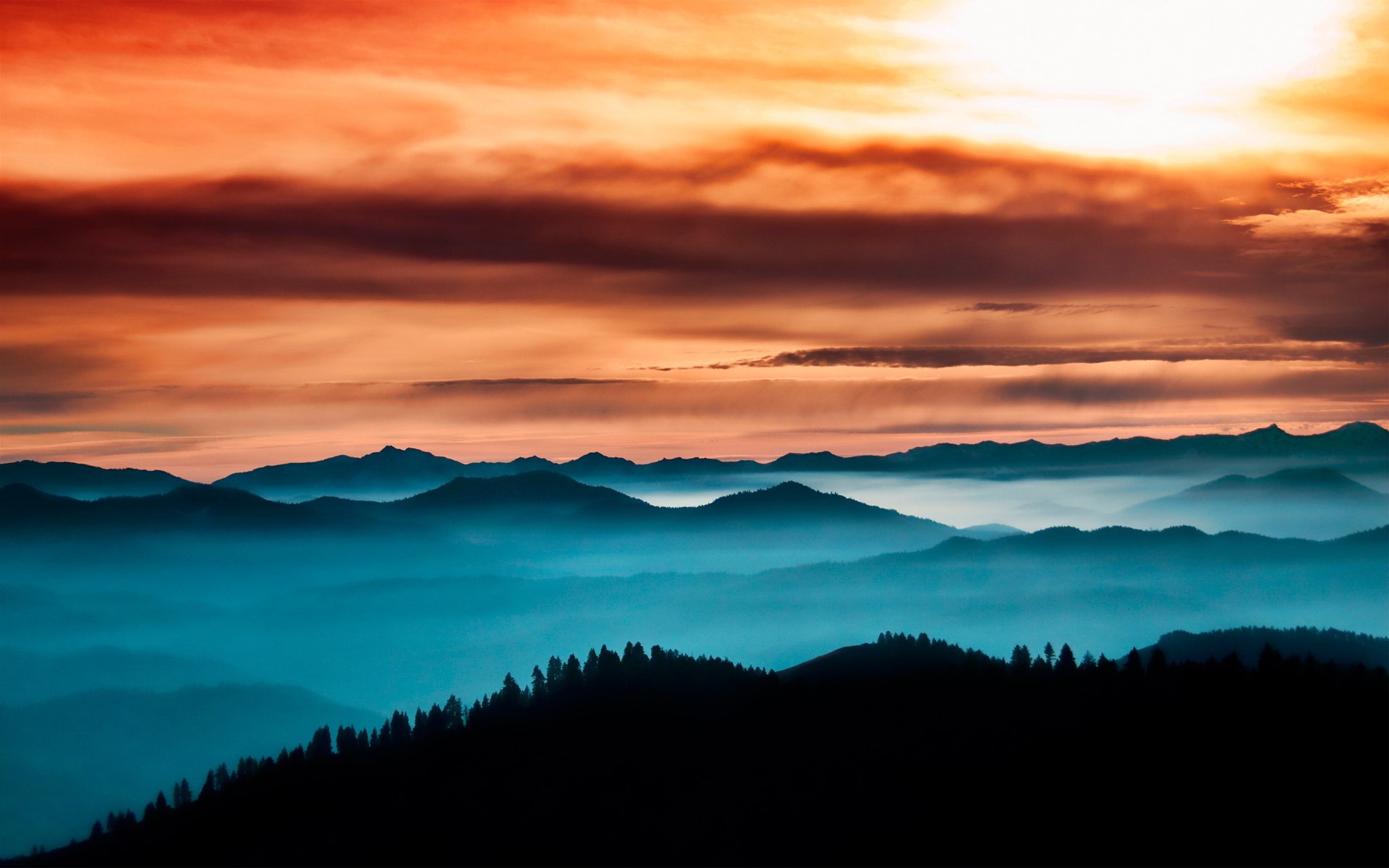 Mountain range at sunset with orange clouds HD Wallpaper