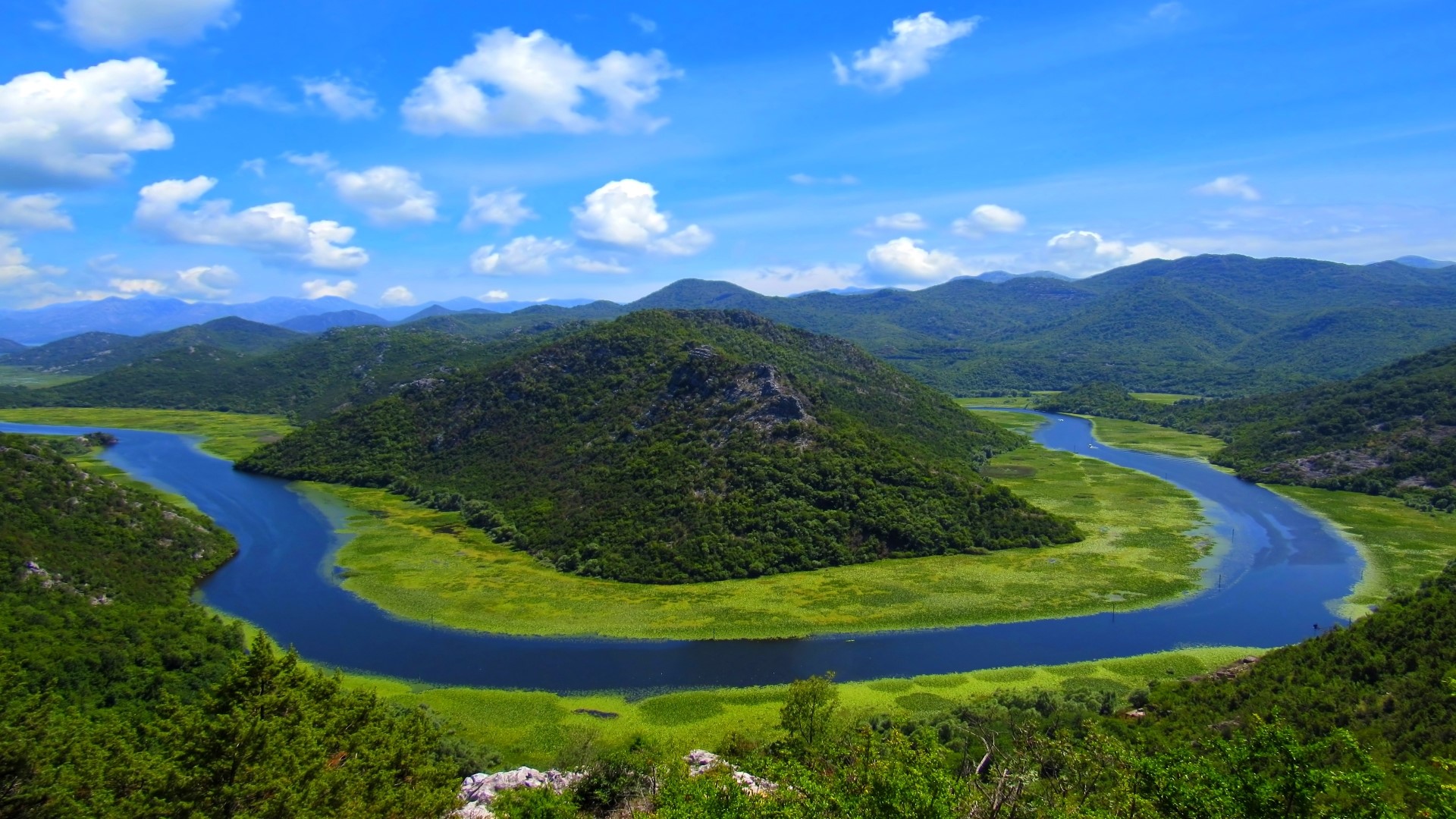 Meandering River Through Green Mountains Under Blue Sky HD Wallpaper