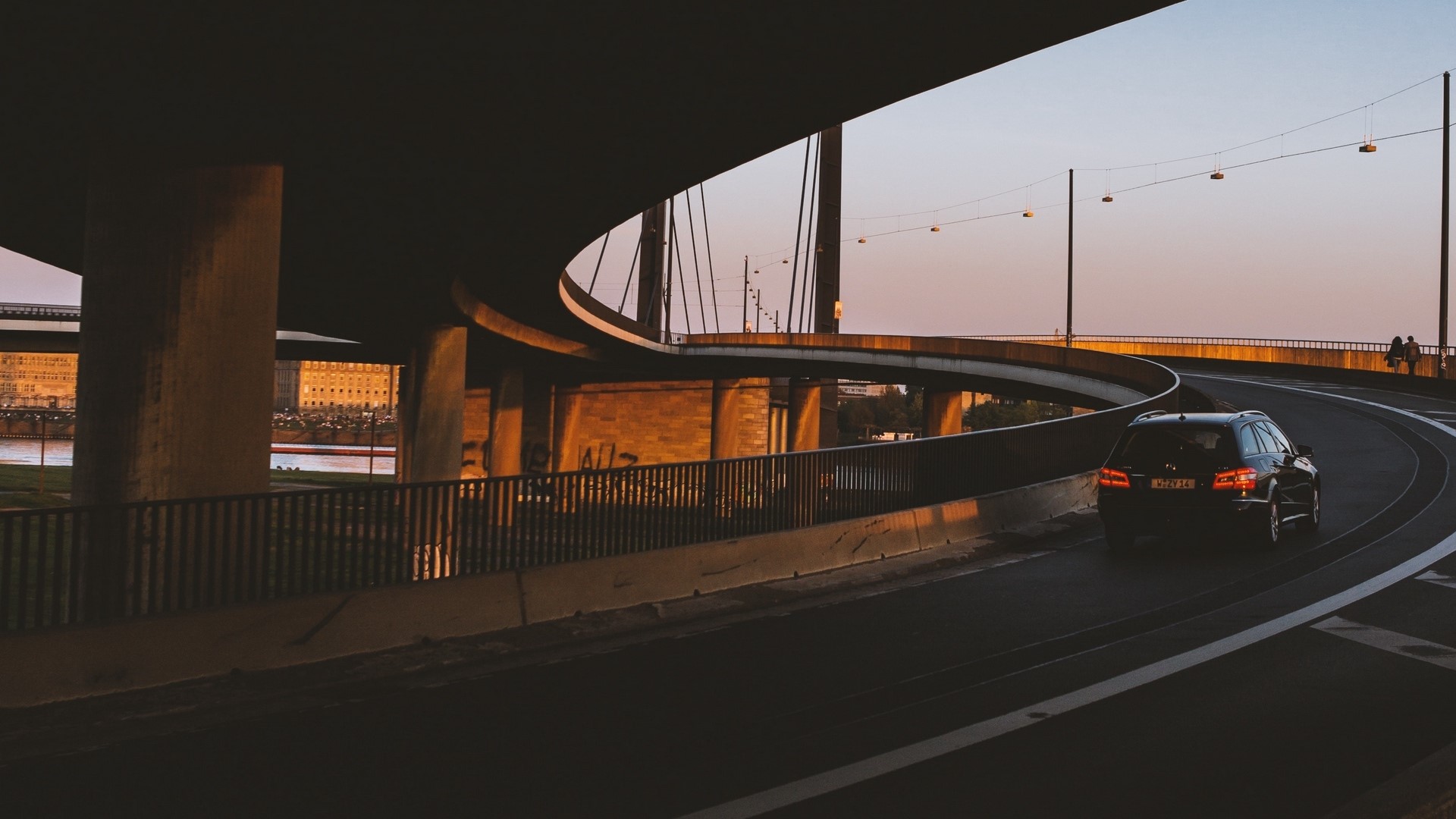 Black car driving on a bridge at sunset HD Wallpaper