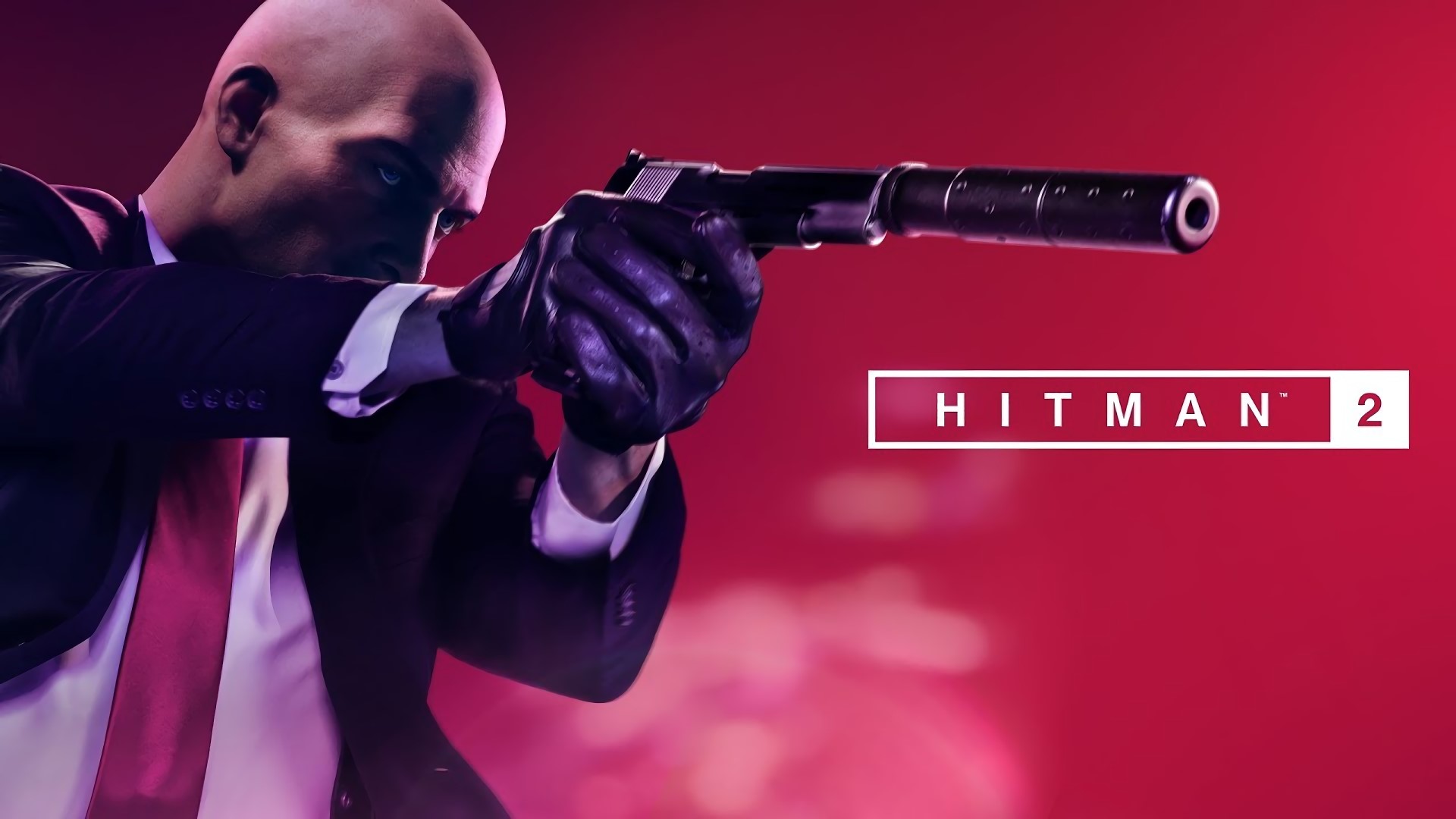 Agent 47 from Hitman 2 holding a silenced pistol HD Wallpaper