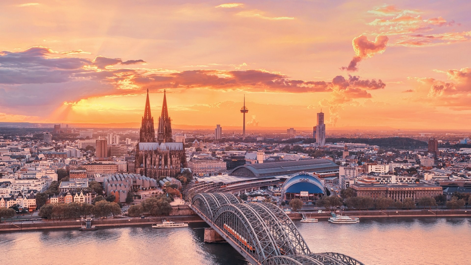 Cologne Cathedral and Hohenzollern Bridge at sunset HD Wallpaper