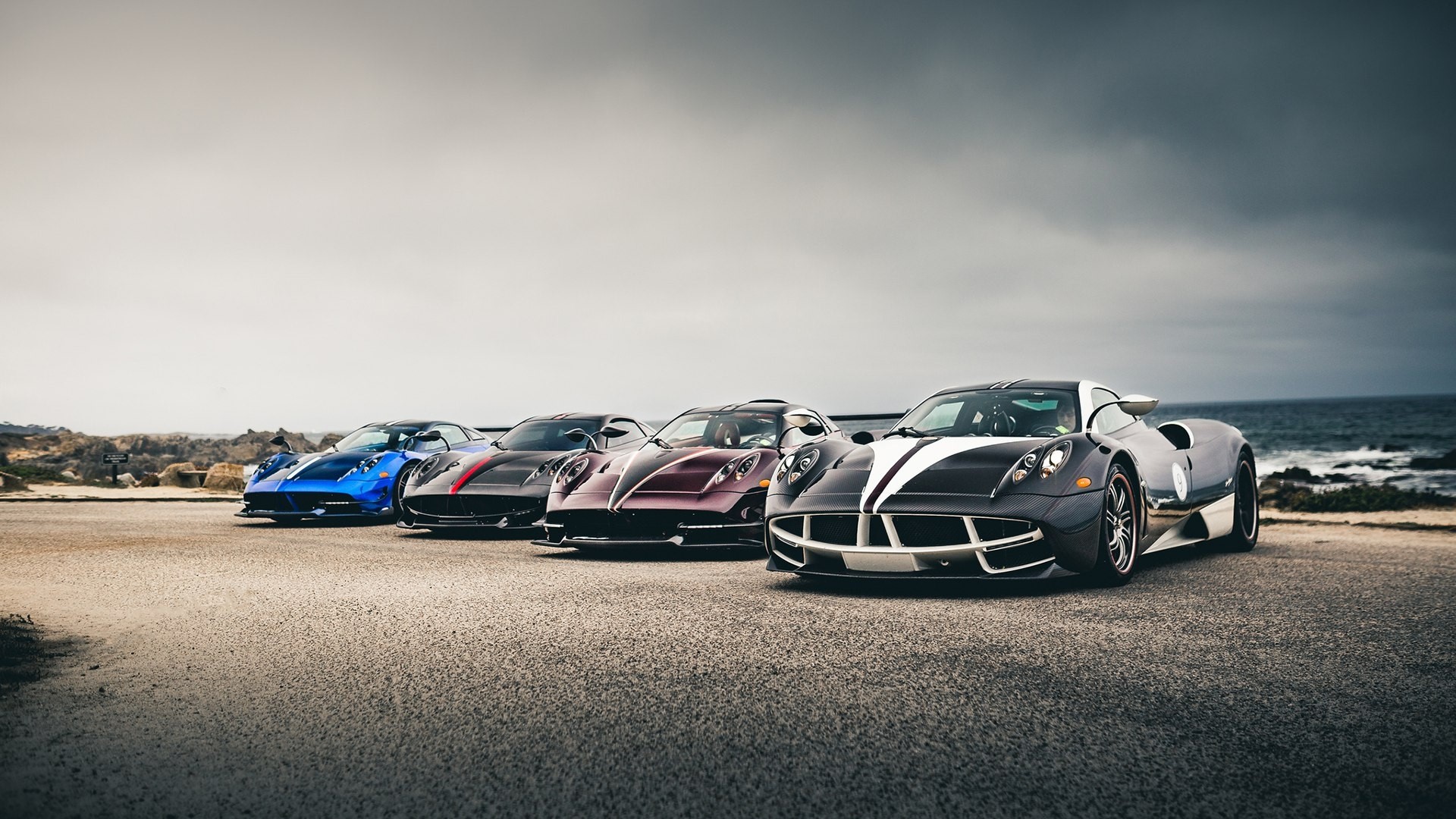 Four Pagani Huayra cars lined up by the ocean HD Wallpaper