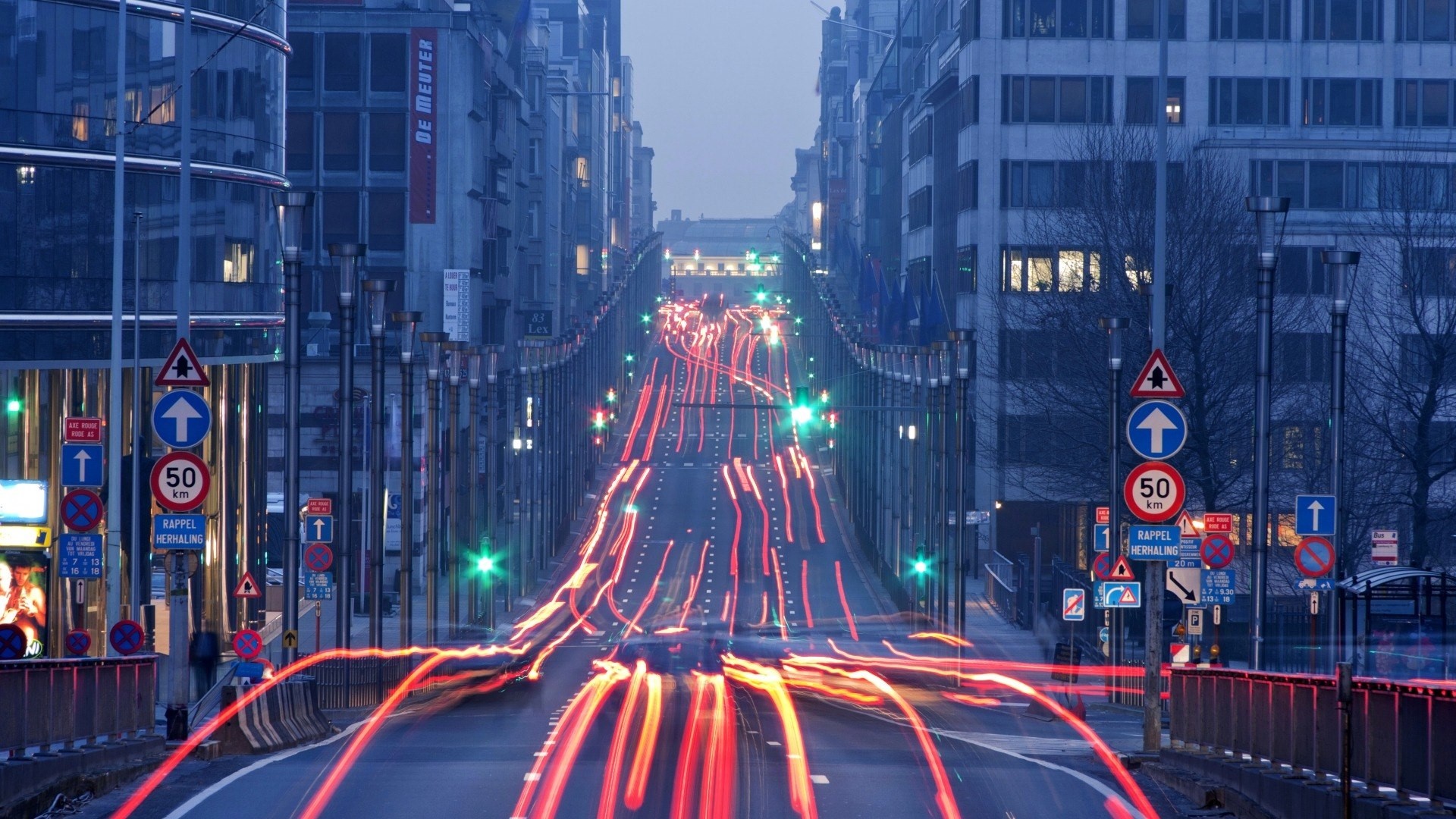Light trails on a city street at dusk HD Wallpaper