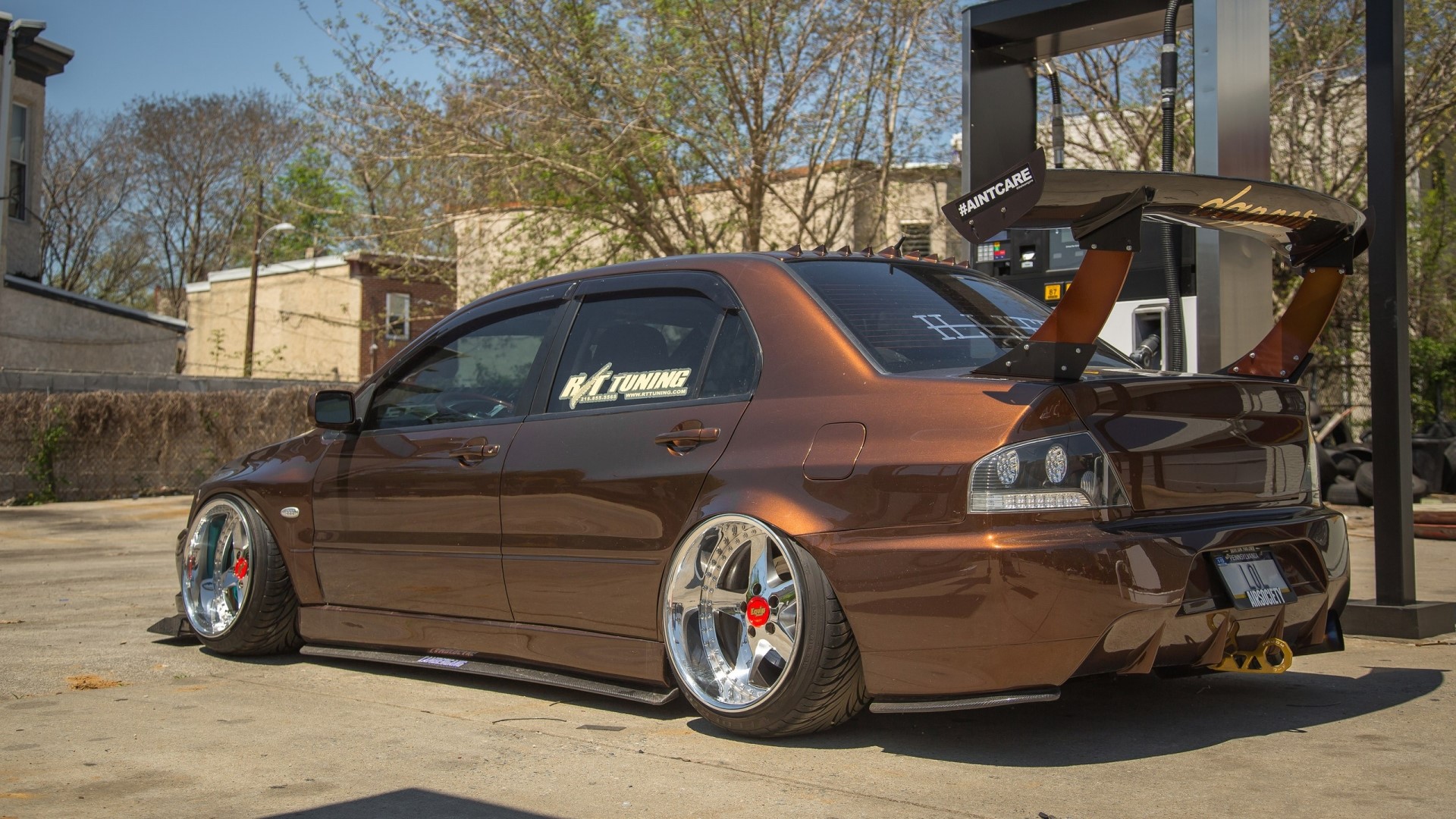 Brown Mitsubishi Lancer Evolution with large spoiler HD Wallpaper