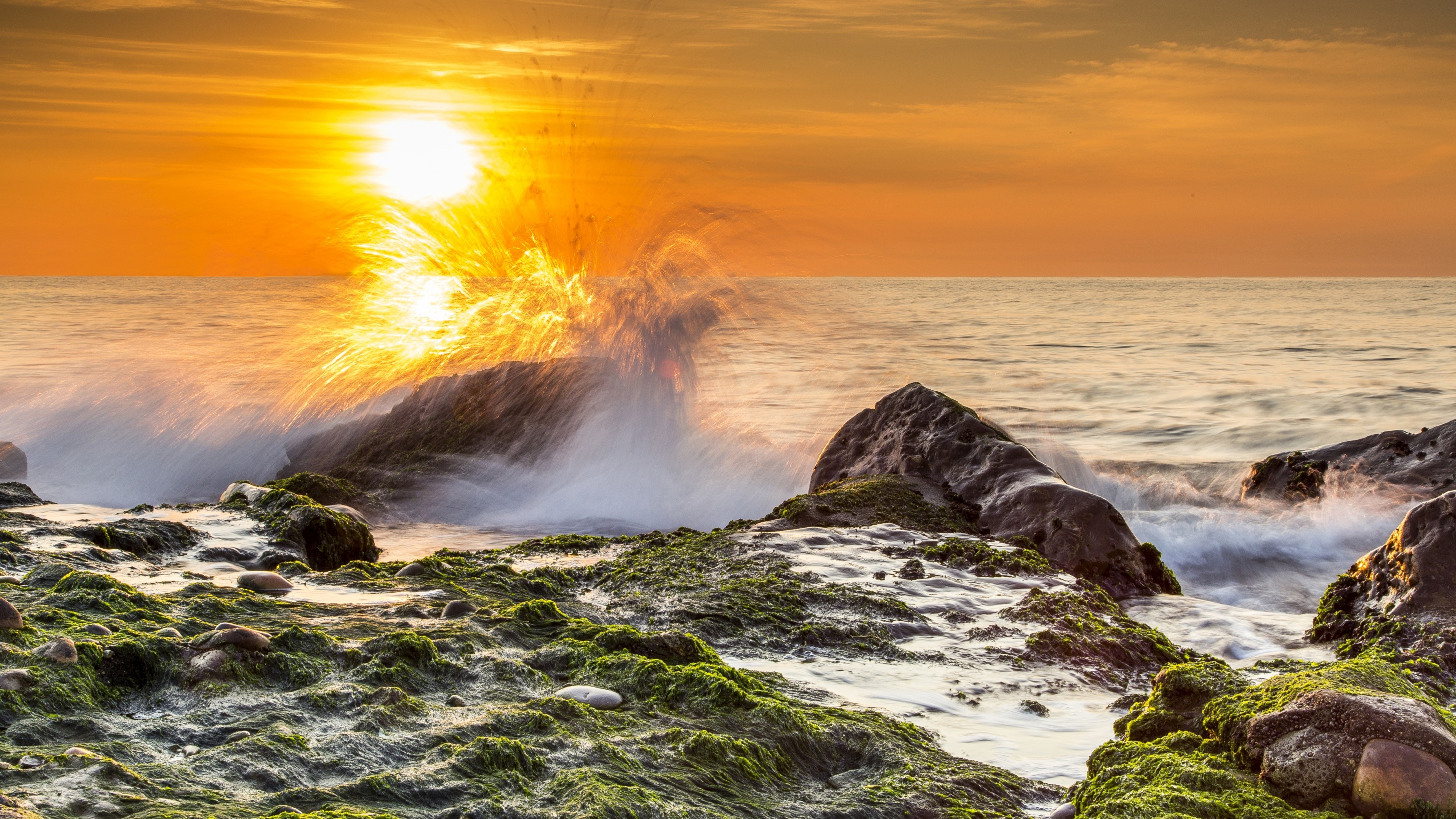 Wave crashing on rocks at sunset HD Wallpaper