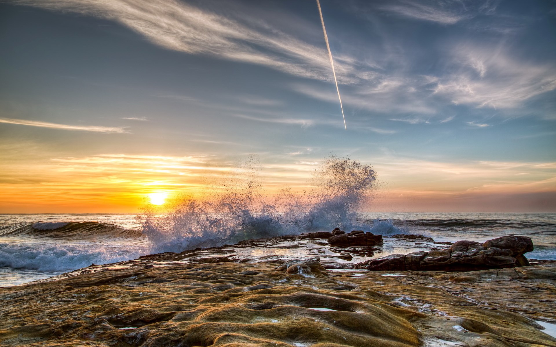 Sunset wave crashing on rocky shore HD Wallpaper