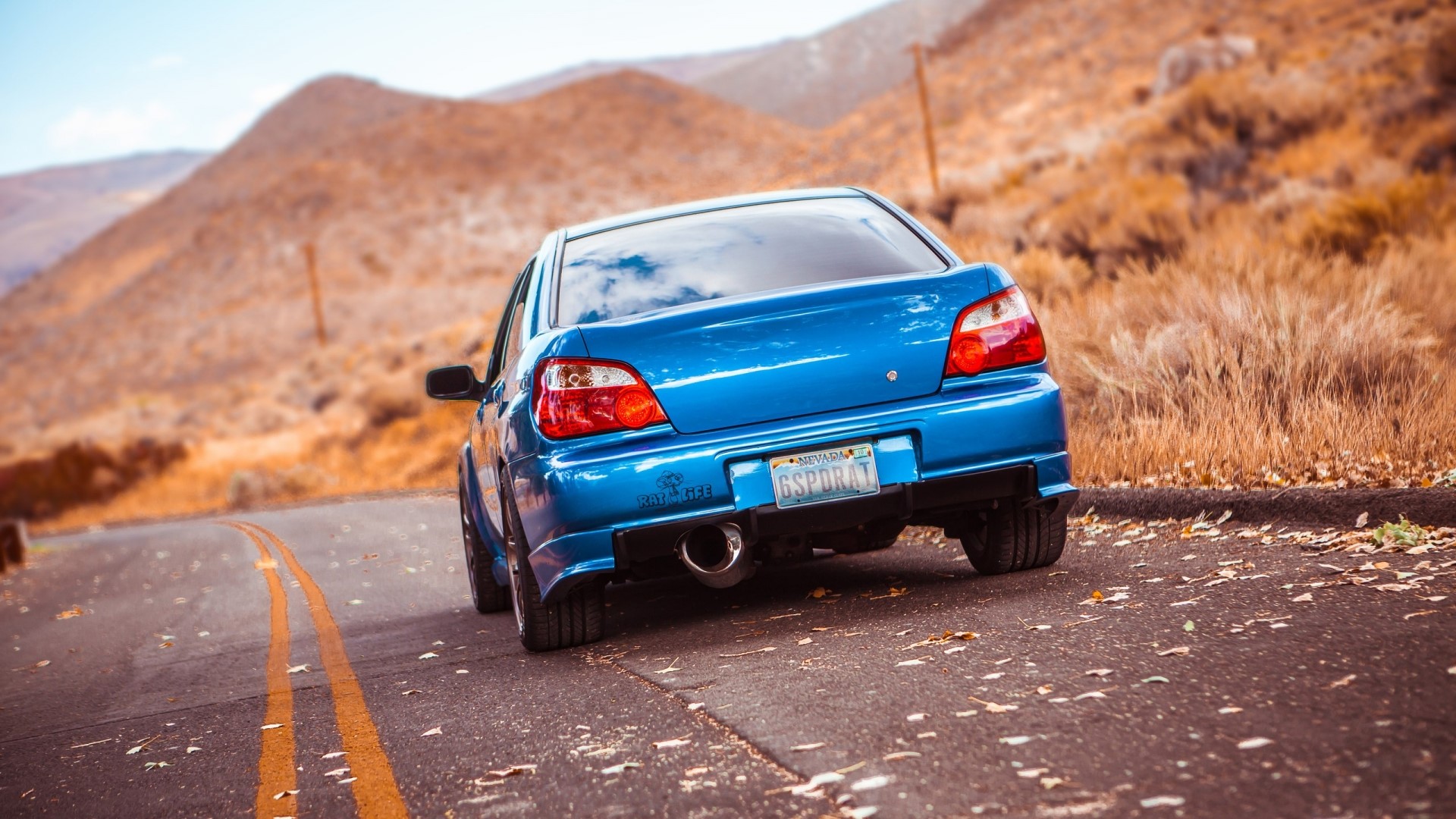 Blue Subaru Impreza on a Mountain Road HD Wallpaper