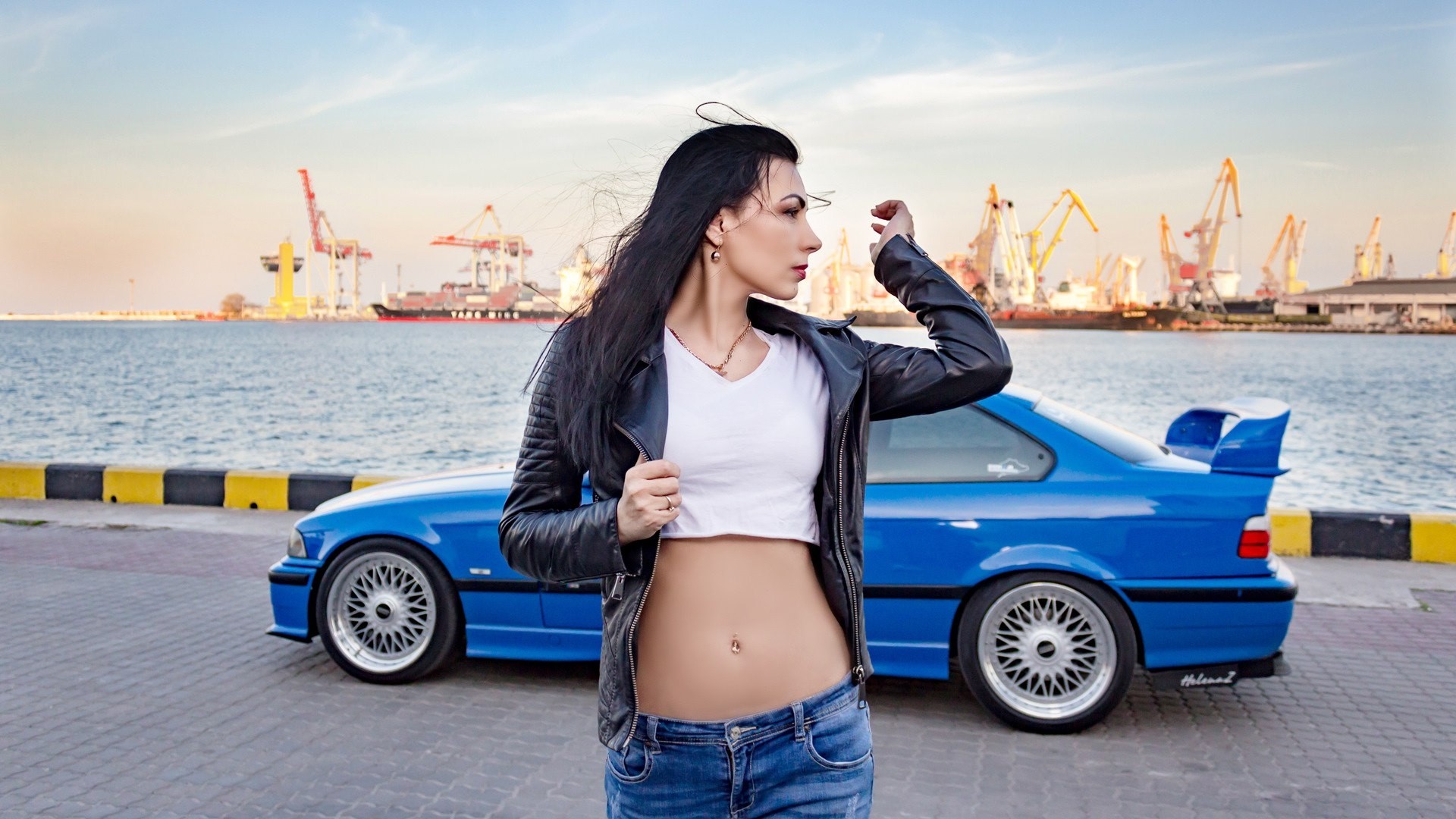 Woman in leather jacket and blue car at port HD Wallpaper