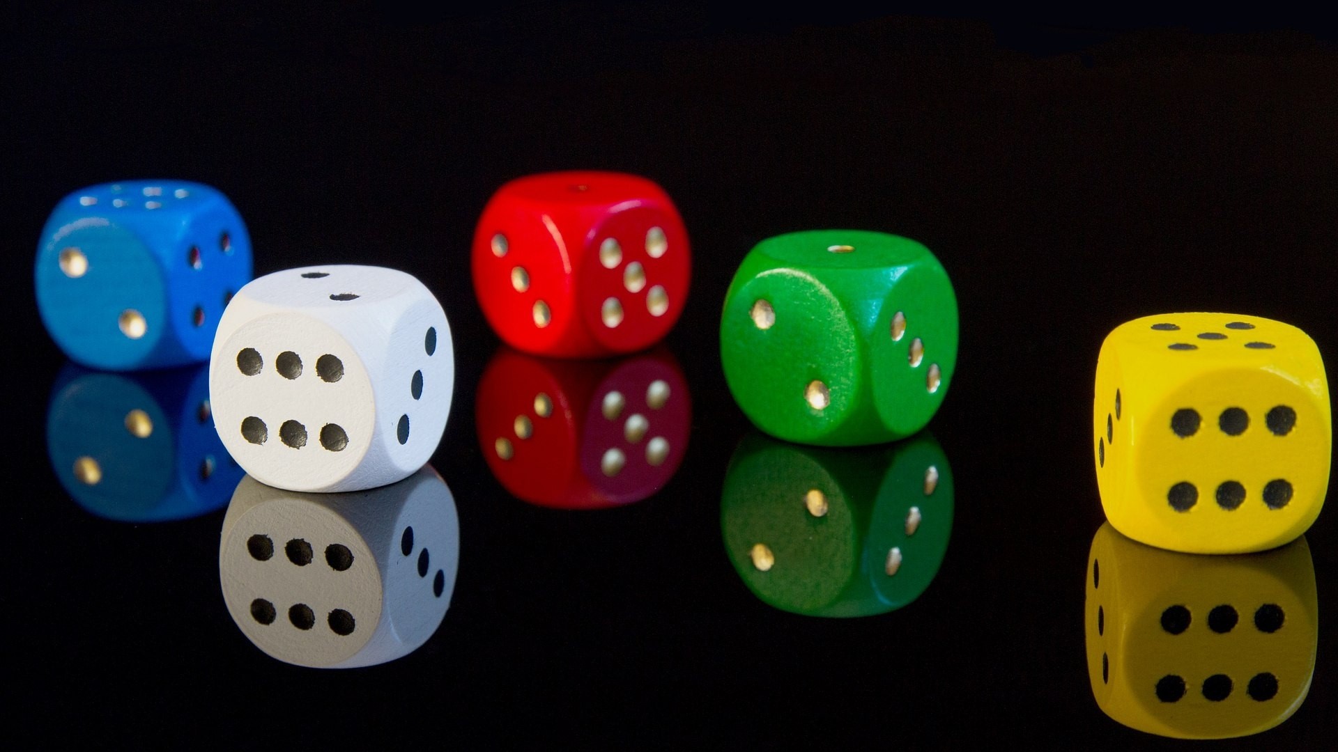 Six colorful dice on a black reflective surface HD Wallpaper