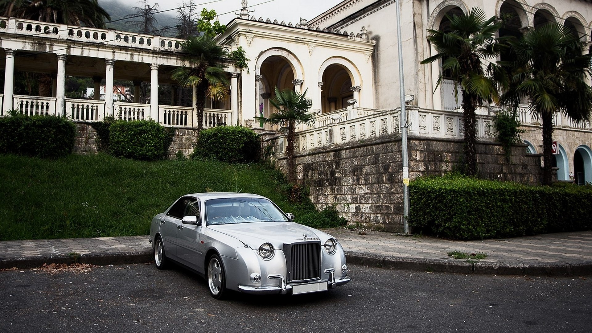Silver Mitsuoka car parked in front of an old building HD Wallpaper