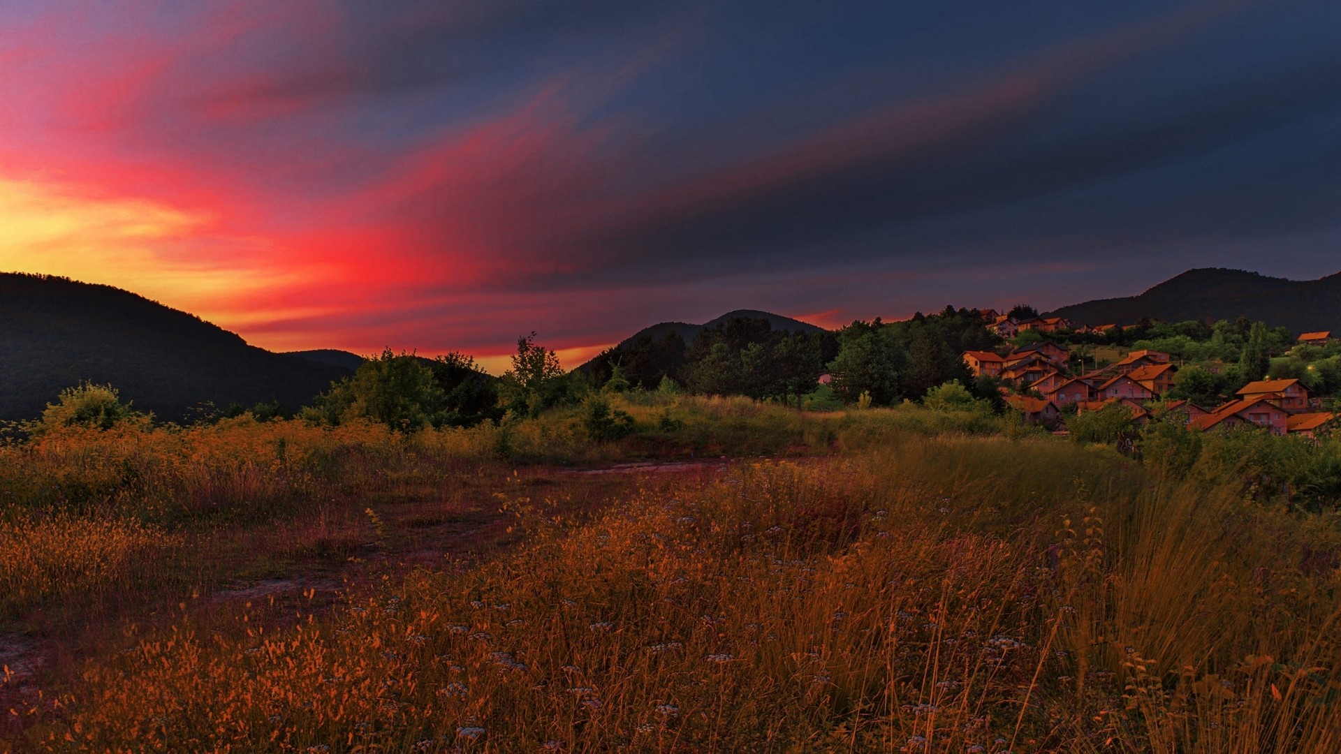 Sunset over a village in the mountains HD Wallpaper