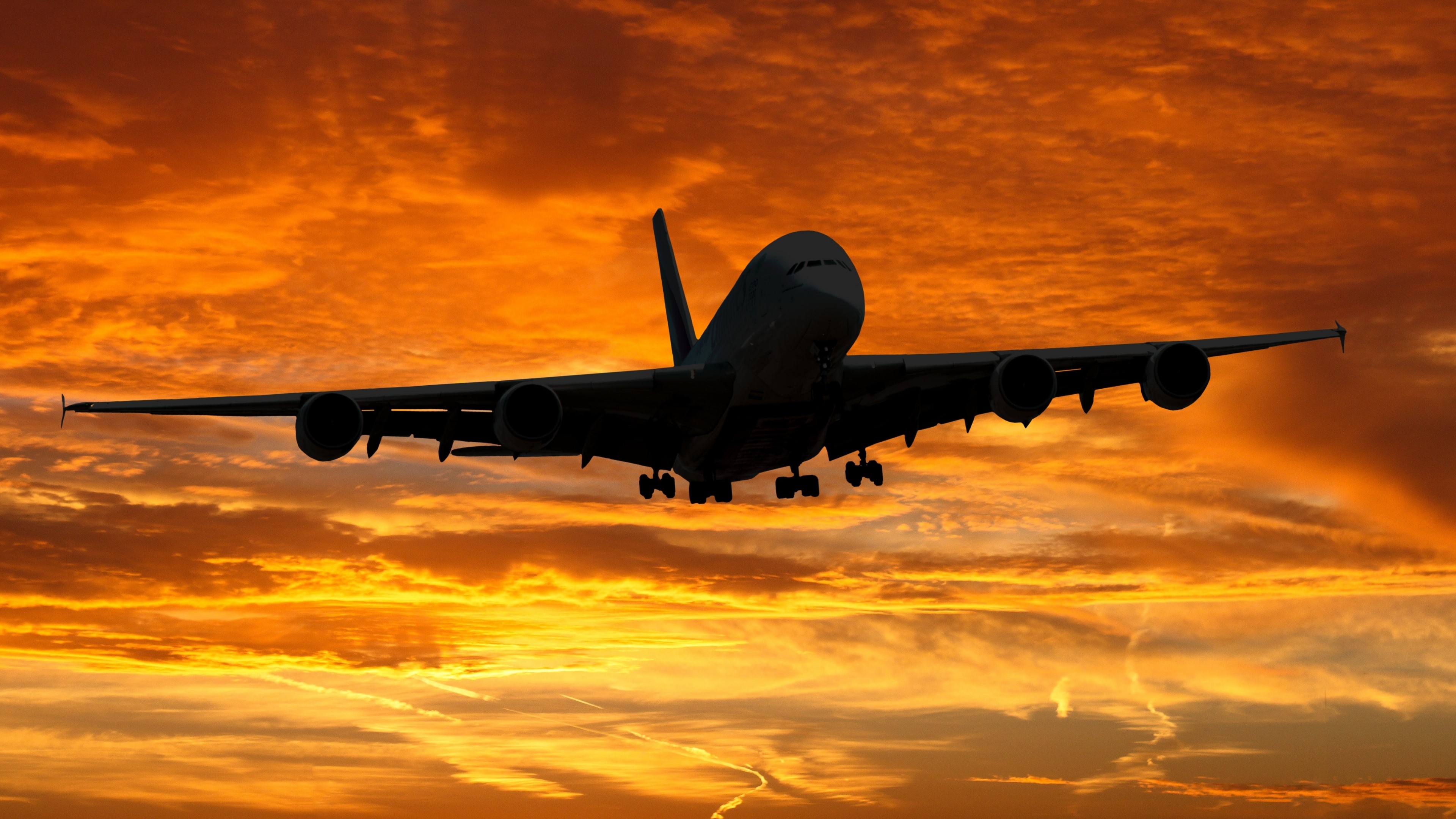 Airplane flying during a vibrant sunset HD Wallpaper