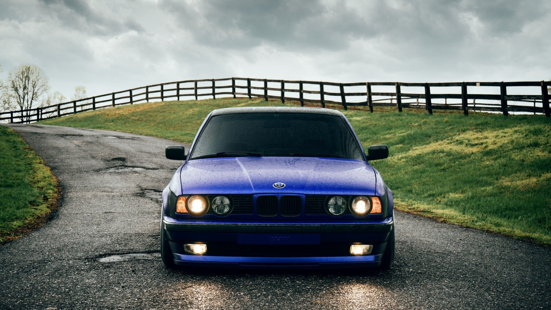 Blue BMW on a Country Road HD Wallpaper