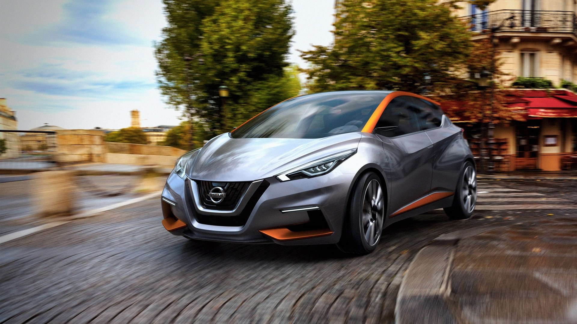 Nissan concept car driving on a cobblestone street HD Wallpaper