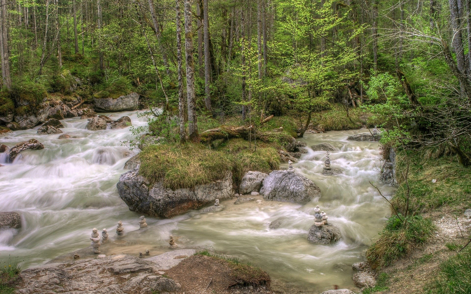 River flowing through a forest with stacked stones HD Wallpaper