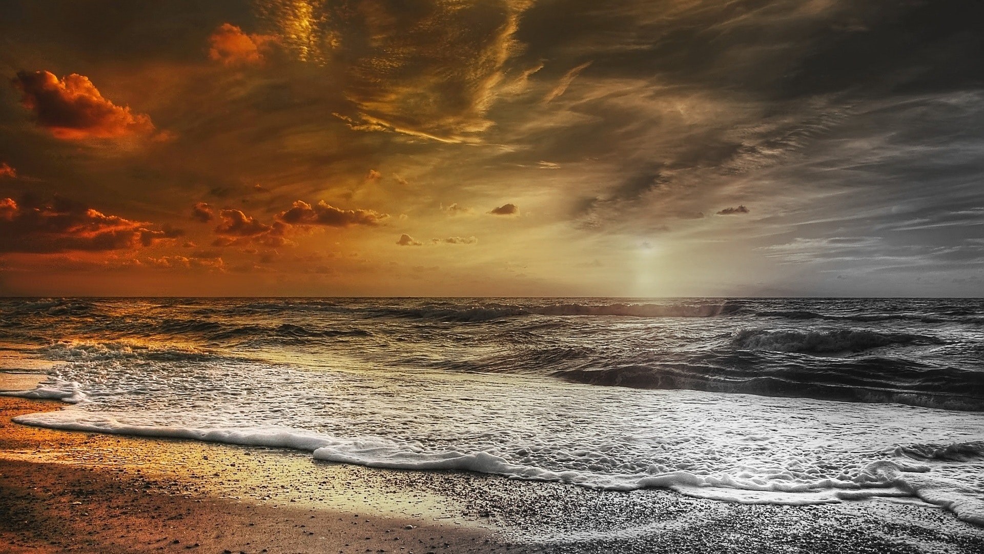 Sunset over a beach with waves HD Wallpaper