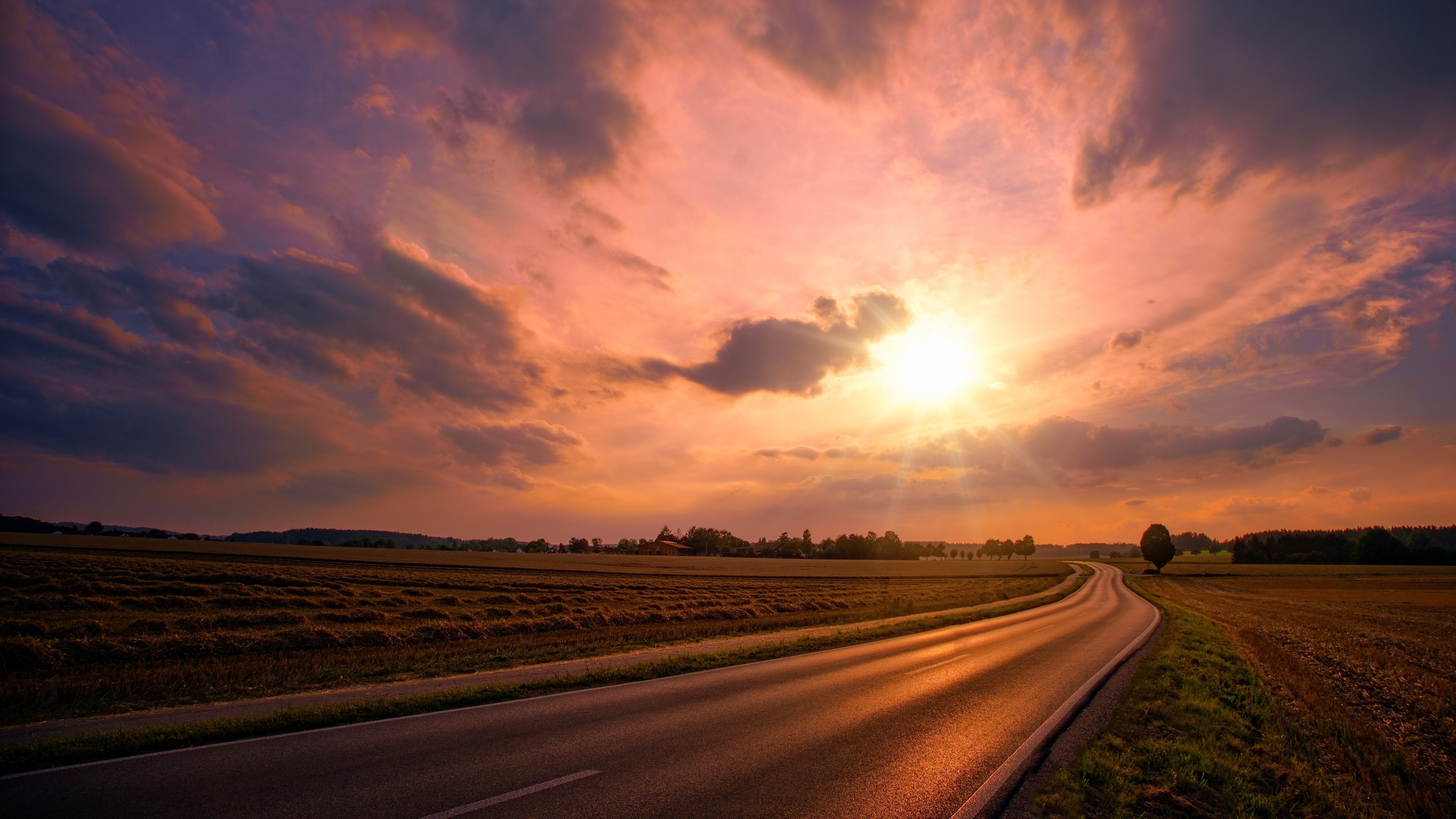 Road through fields at sunset HD Wallpaper