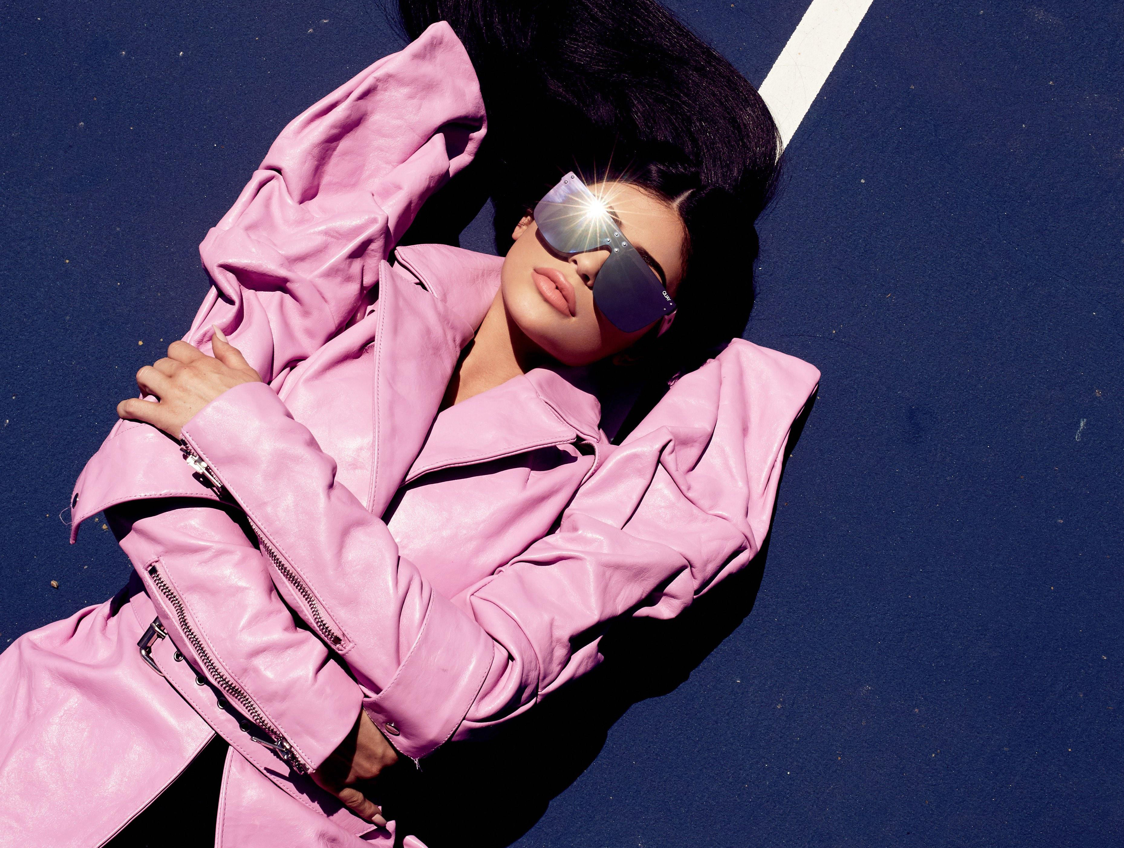 Kylie Jenner in pink coat and sunglasses HD Wallpaper