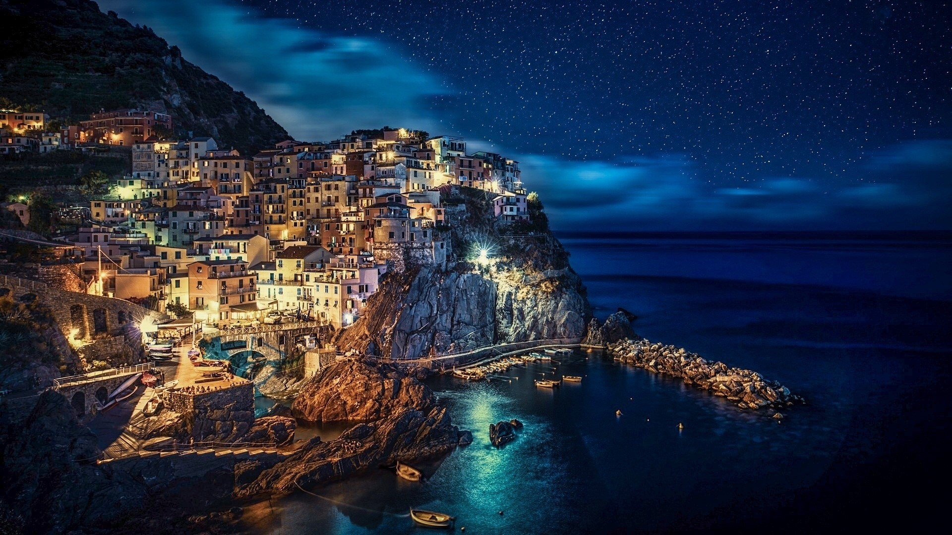 Manarola village at night under starry sky HD Wallpaper
