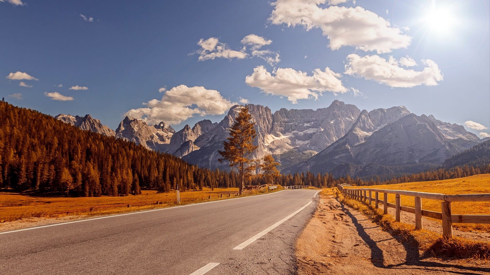Road through the Alps with autumn trees and mountains HD Wallpaper