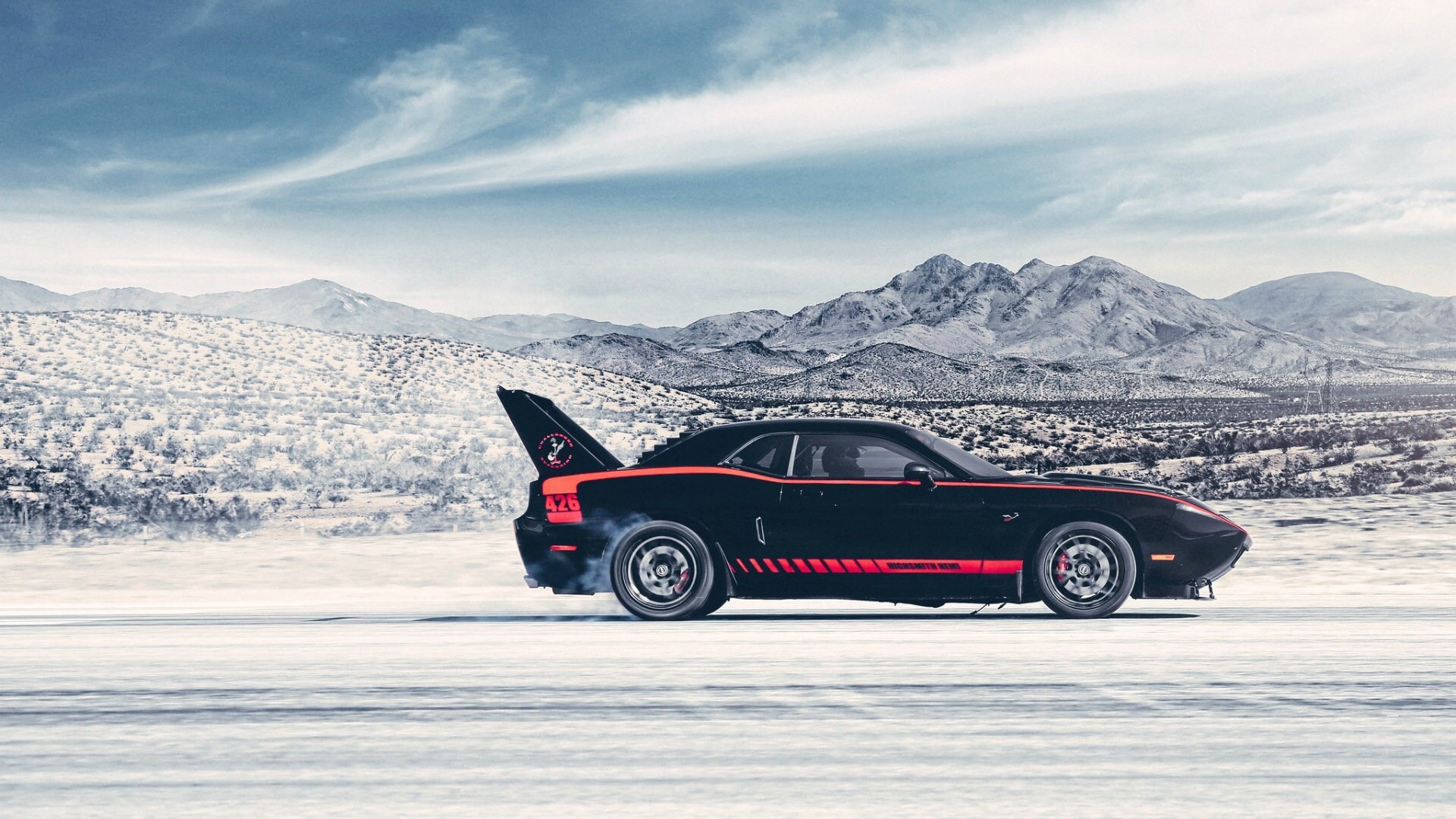 Black Dodge Challenger with red stripes on snowy road HD Wallpaper