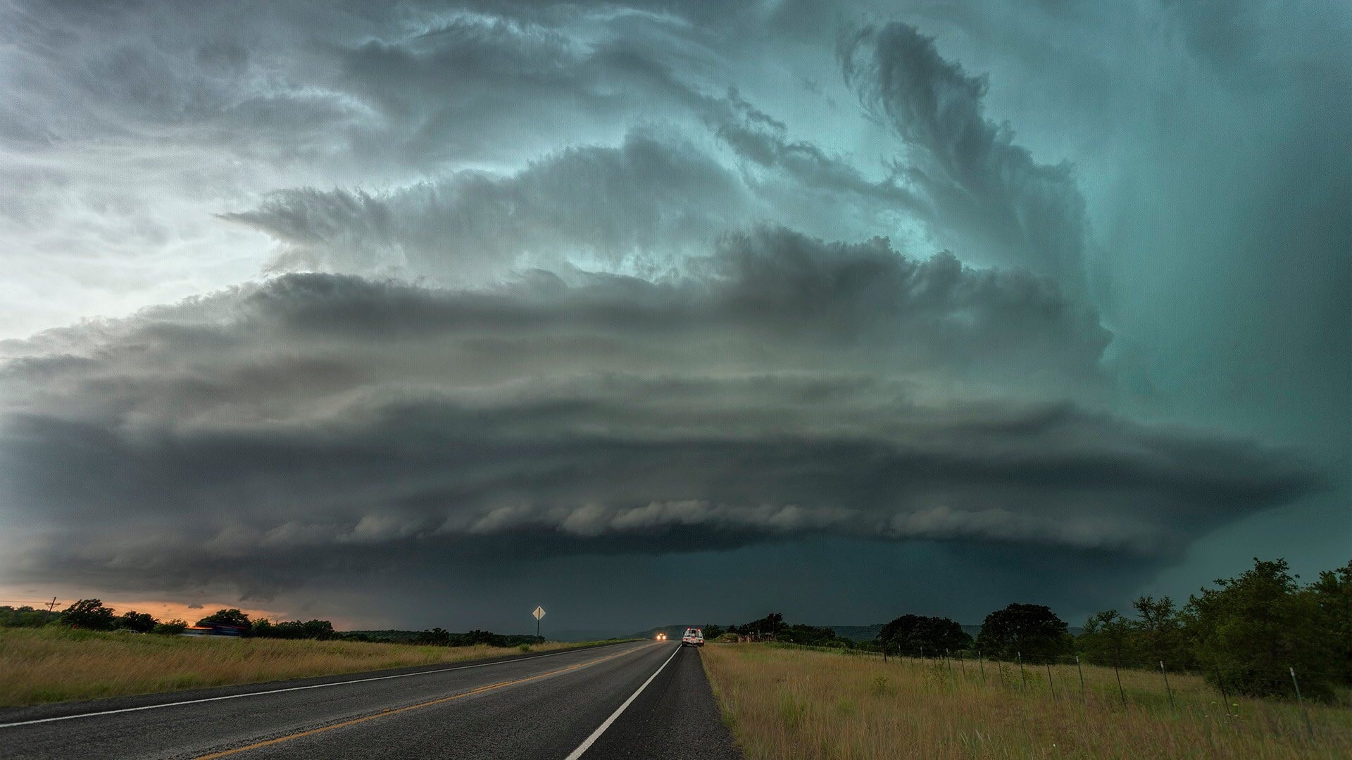 Stormy clouds over a highway HD Wallpaper