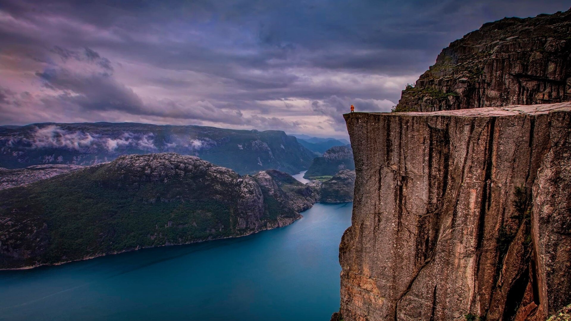 Person on Preikestolen cliff overlooking Lysefjord, Norway HD Wallpaper
