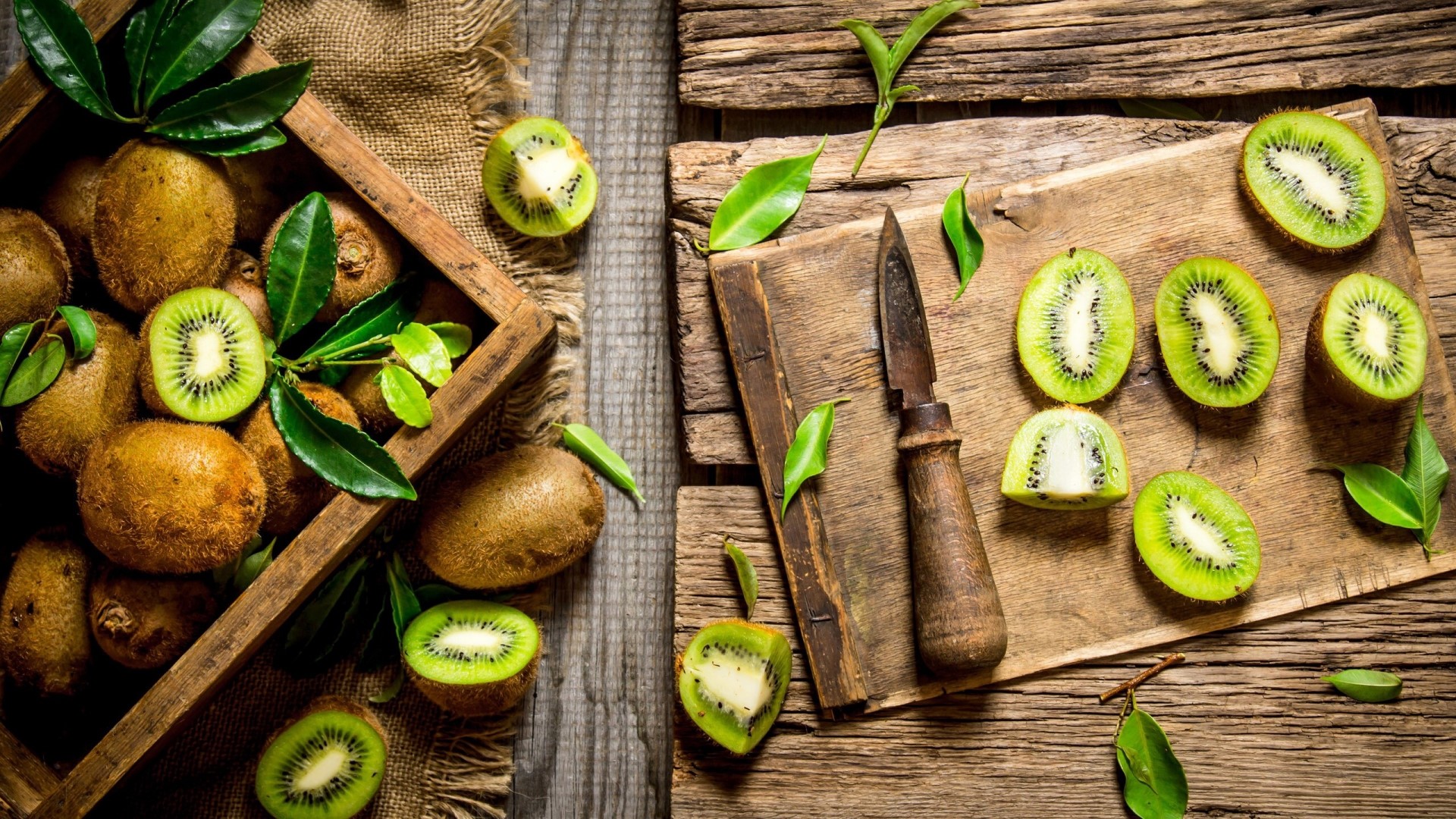 Whole and sliced kiwis on wooden boards HD Wallpaper