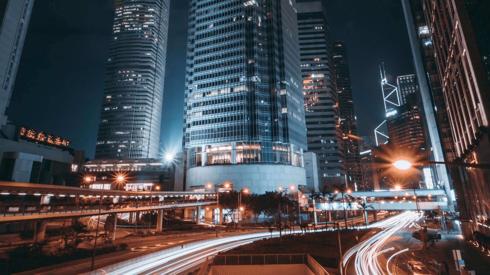 Hong Kong skyscrapers at night with light trails HD Wallpaper