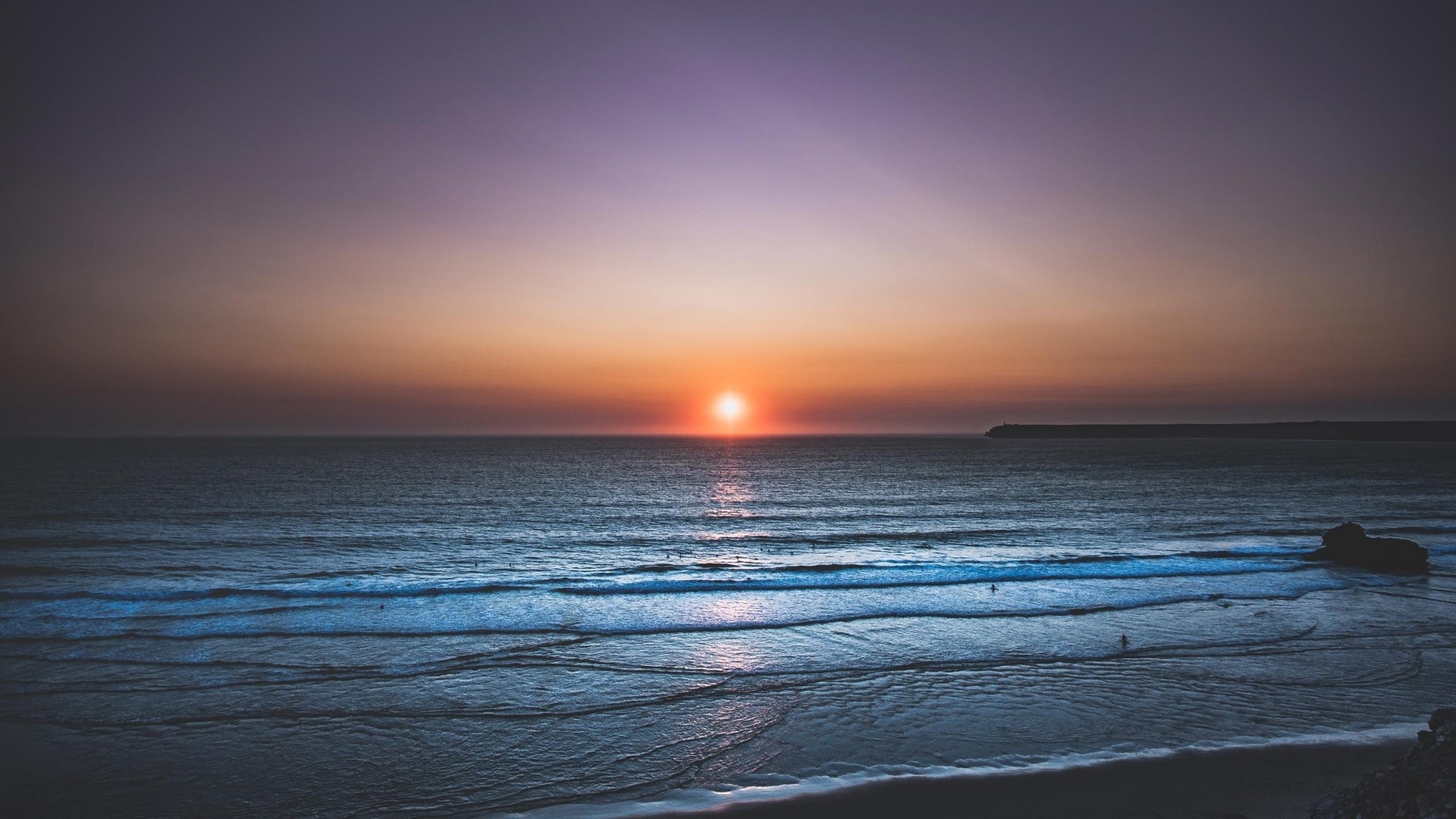 Sunset over the ocean with waves HD Wallpaper