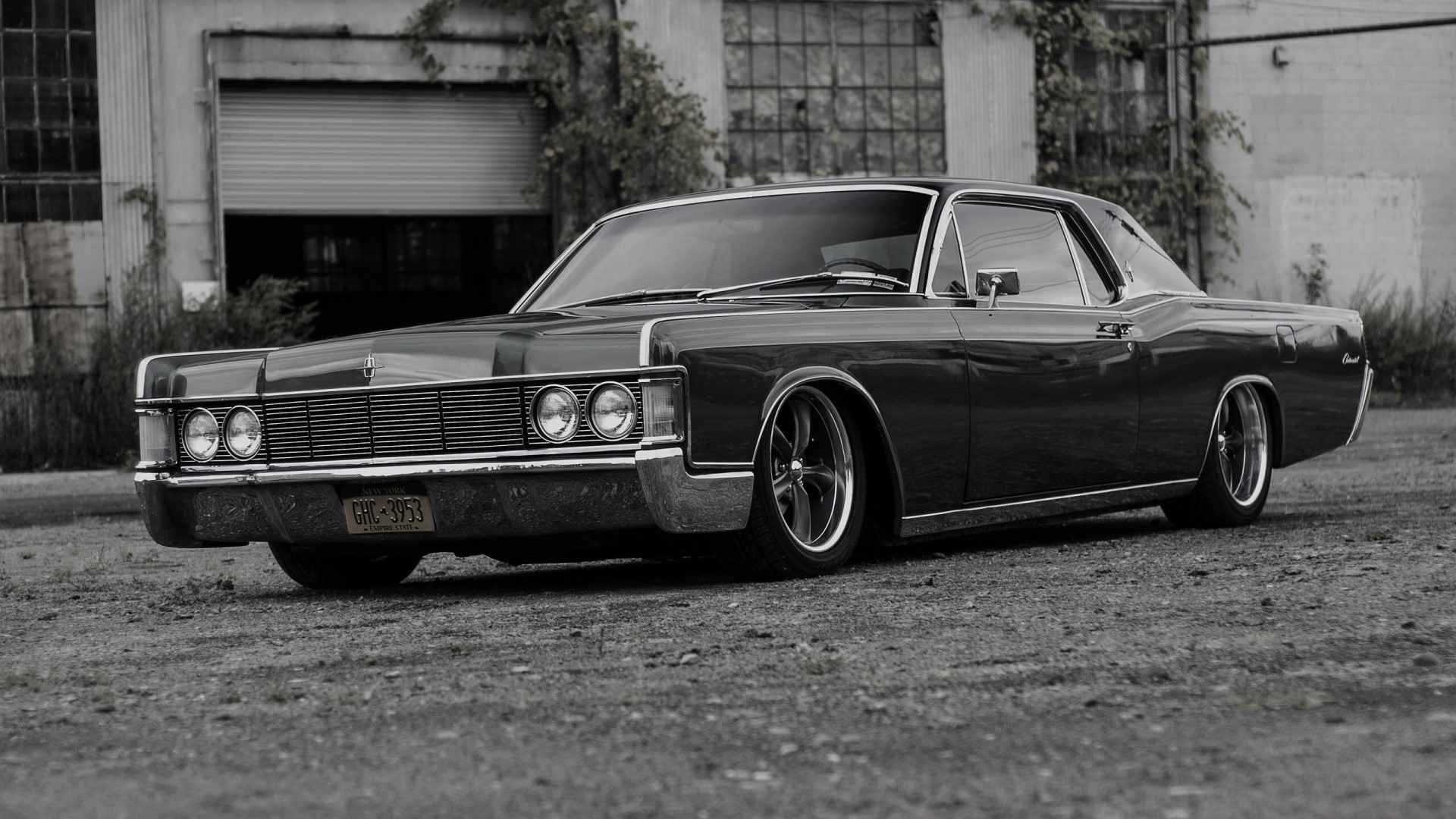 Lincoln Continental parked in front of an industrial building HD Wallpaper