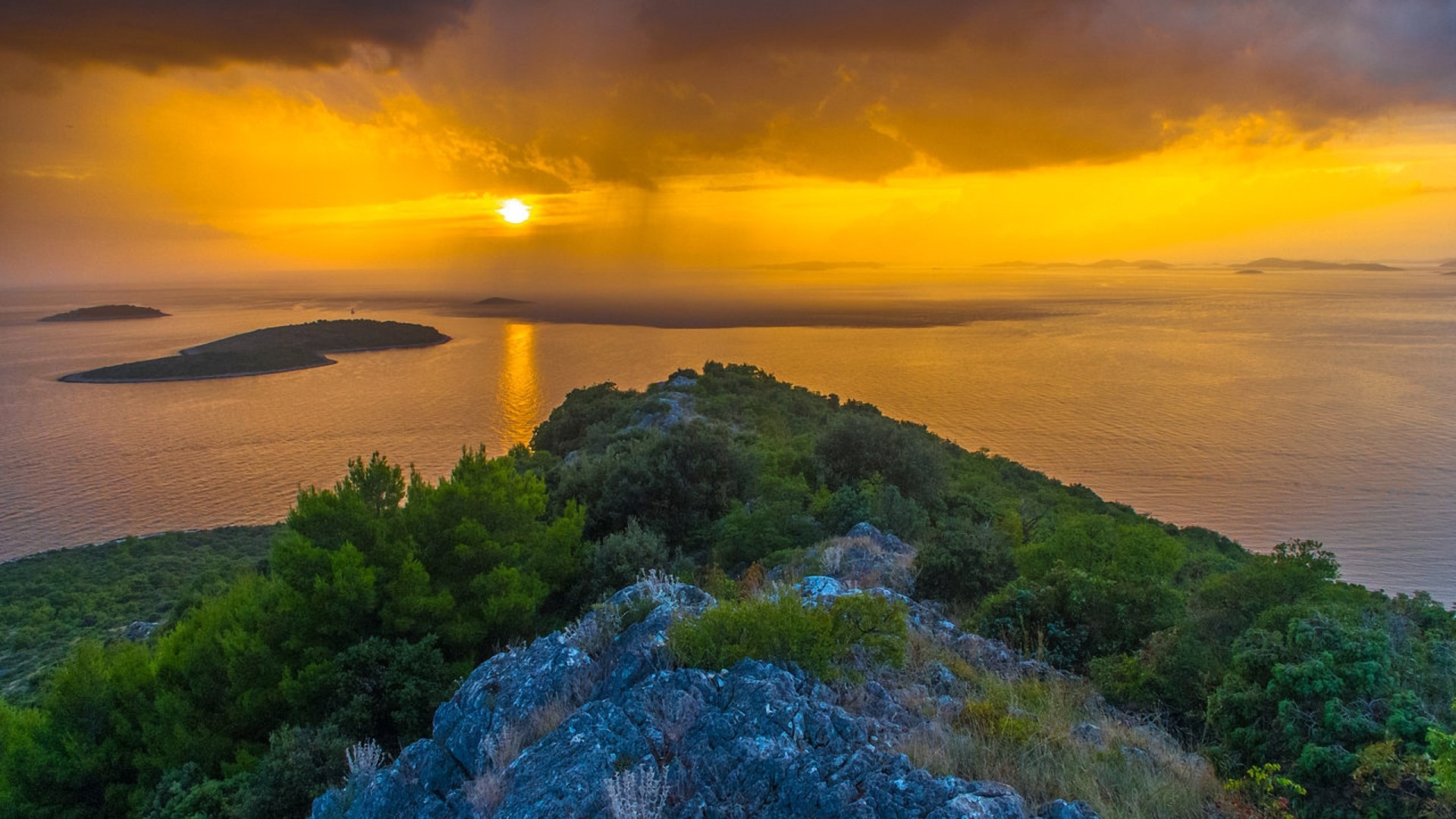 Sunset over islands and sea from a rocky peak HD Wallpaper