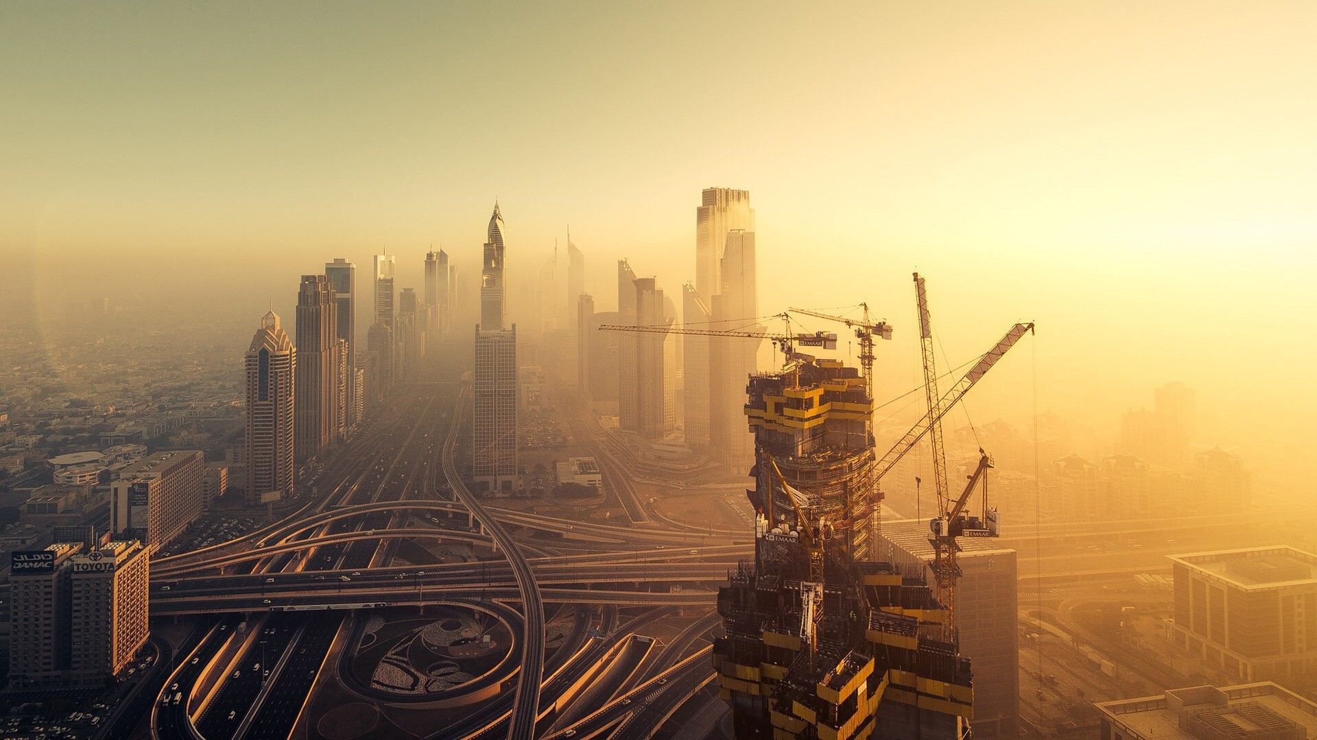 Dubai skyline with skyscrapers and construction cranes HD Wallpaper