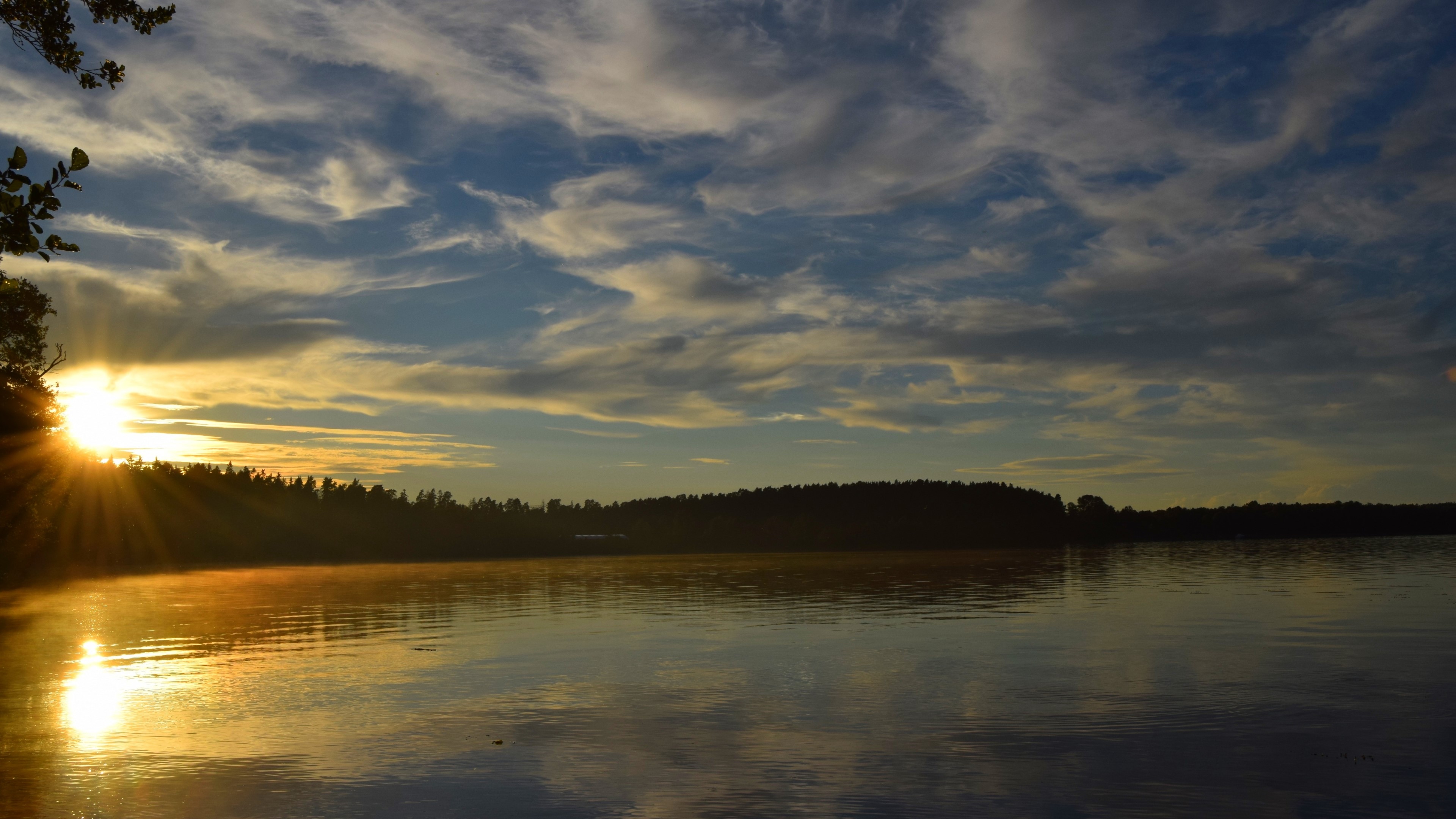 Sunset over a lake with trees and clouds HD Wallpaper