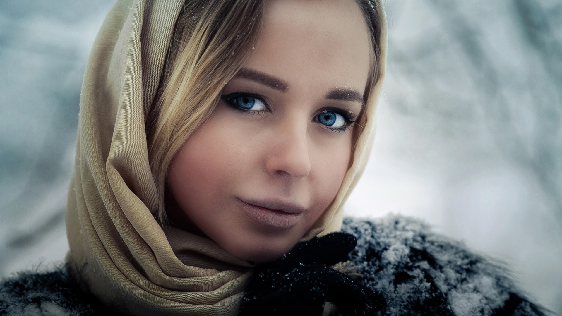 Woman with blue eyes wearing a headscarf in the snow HD Wallpaper