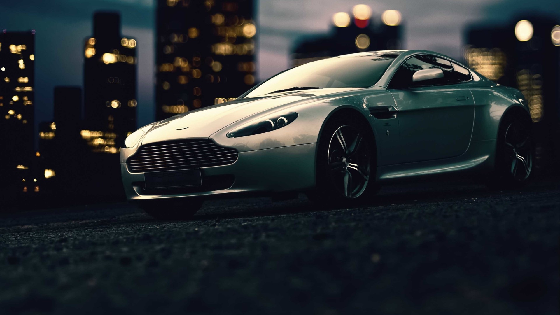Aston Martin sports car at night in a city HD Wallpaper