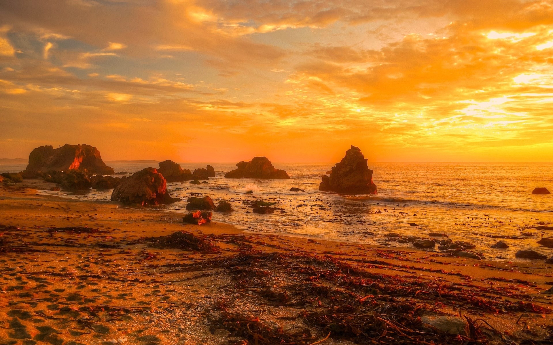 Sunset over rocky beach with ocean waves HD Wallpaper
