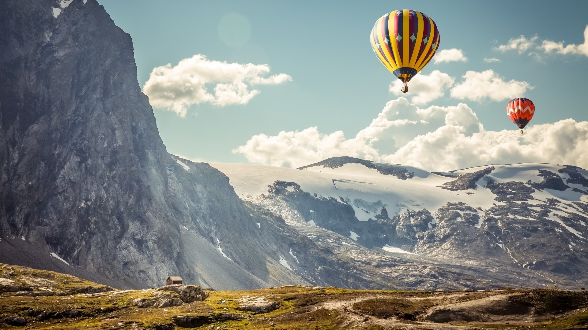Hot air balloons over snowy mountains HD Wallpaper